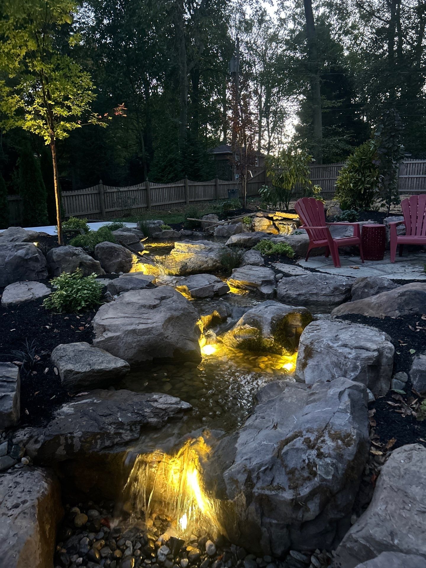 Pondless waterfall in Elkton, MD with natural stone patio and steppingstones crossing moving stream 