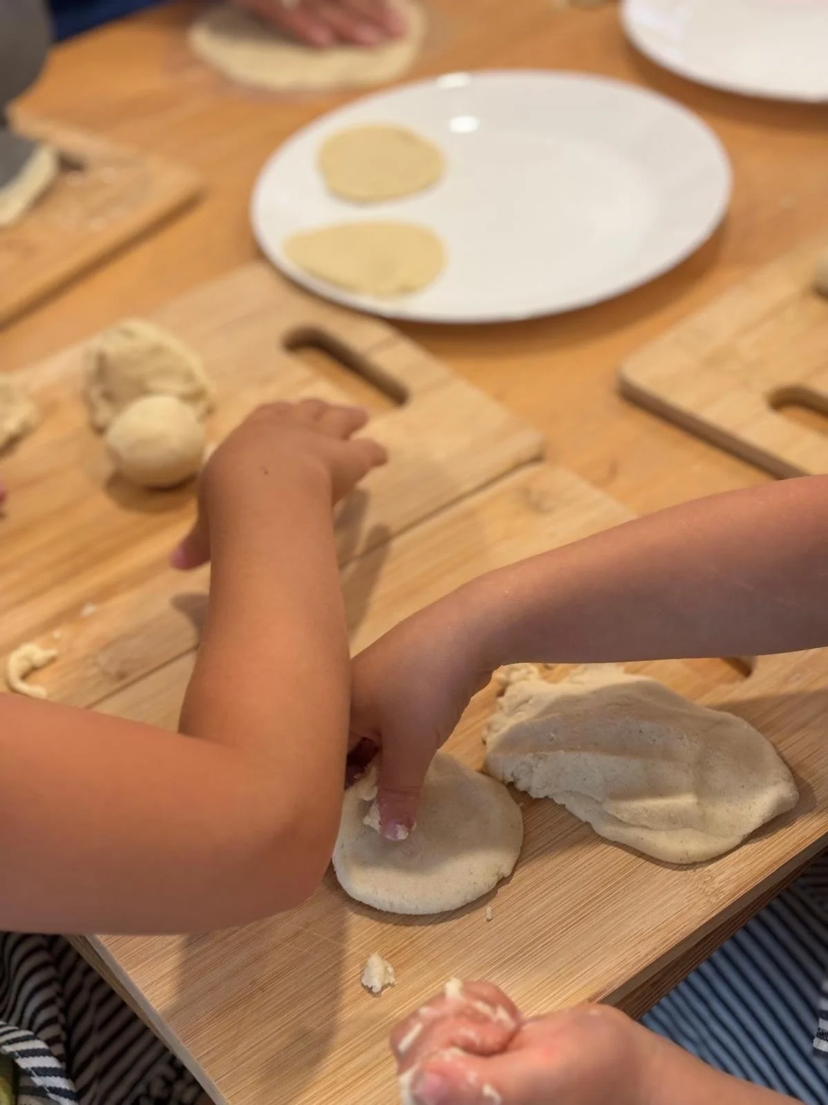 Preschooler stirring bowl at Montessori summer camp in Austin Spanish immersion program