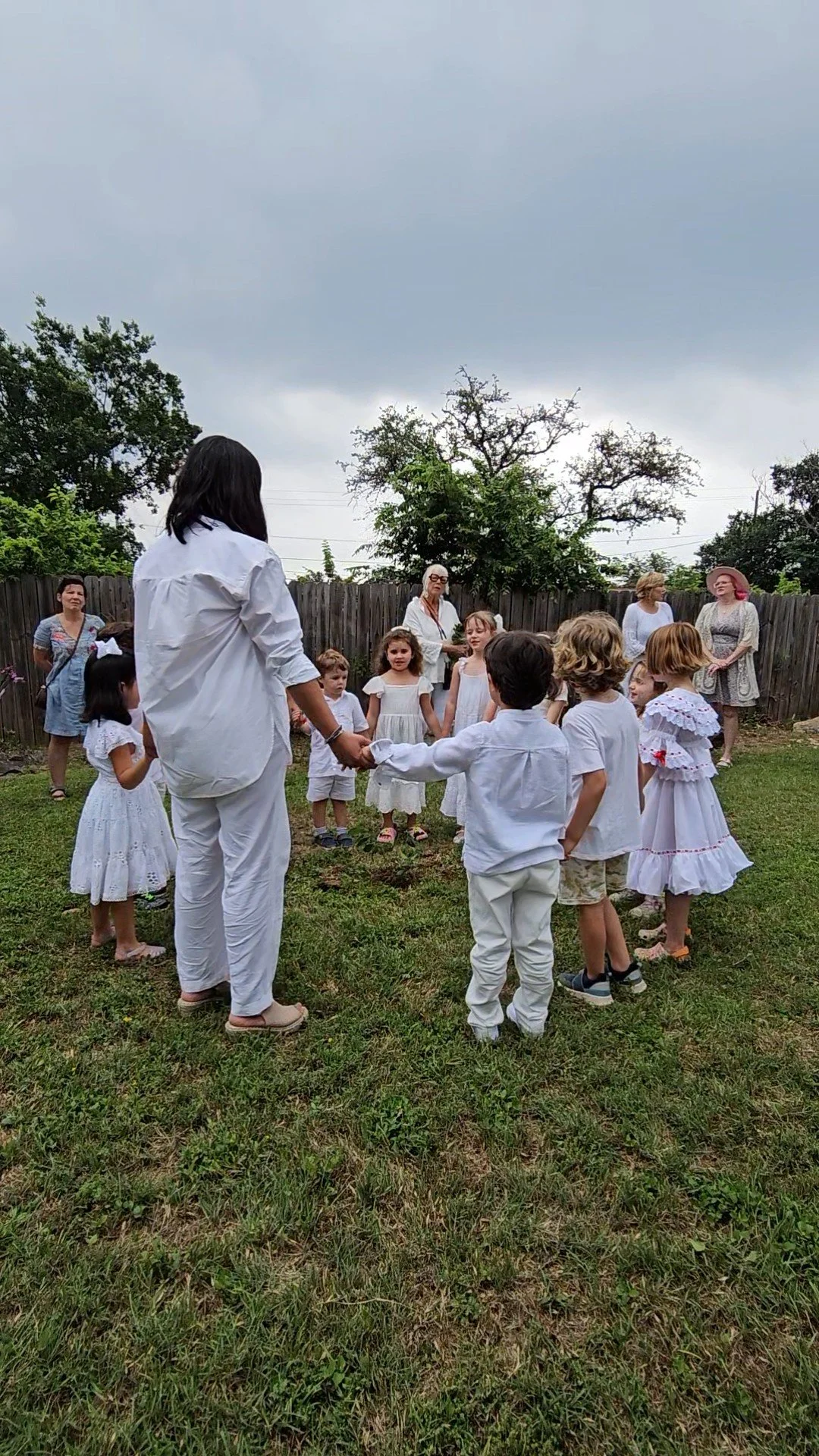 Teacher and children at circle time – Spanish immersion Montessori in Austin