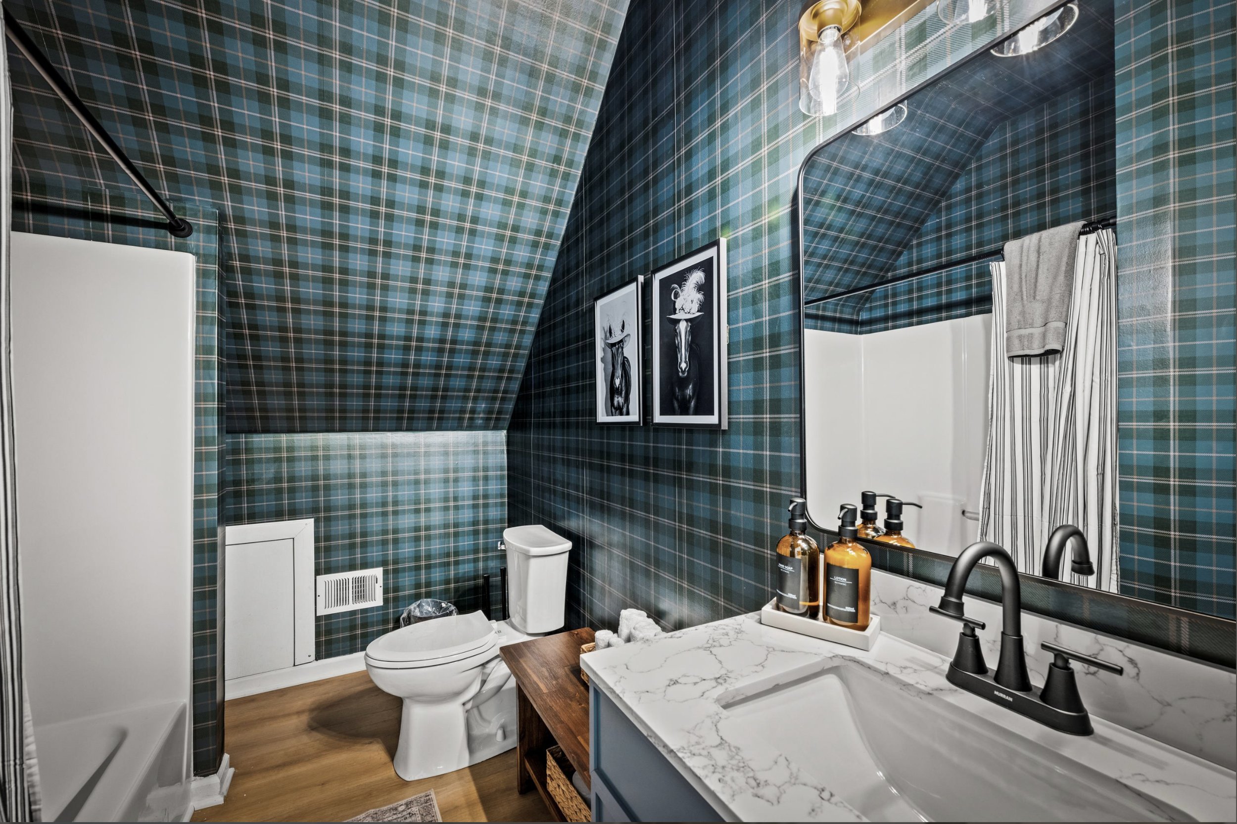 Plaid wallpaper is the focal point of this shared bathroom. 