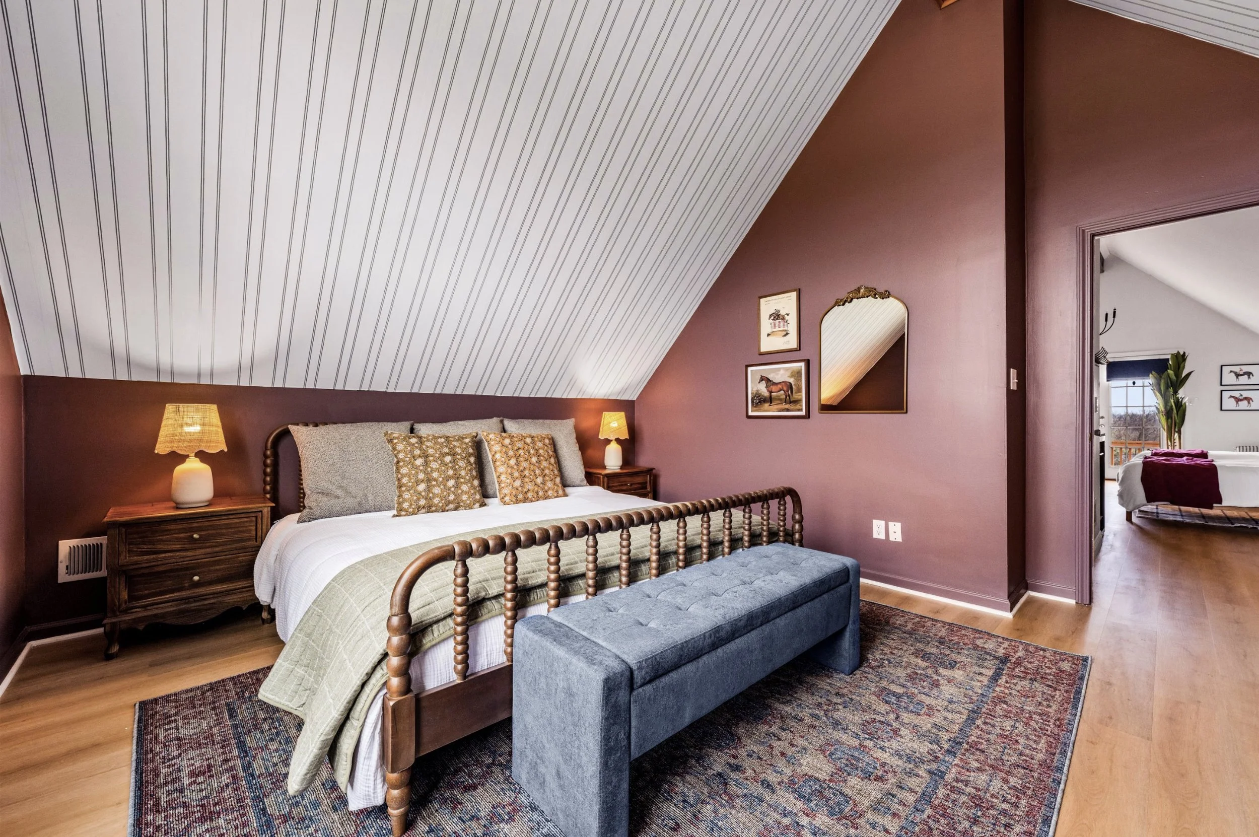 Traditional bedroom design with modern touches. Wallpaper helps to emphasize the slanted ceilings.
