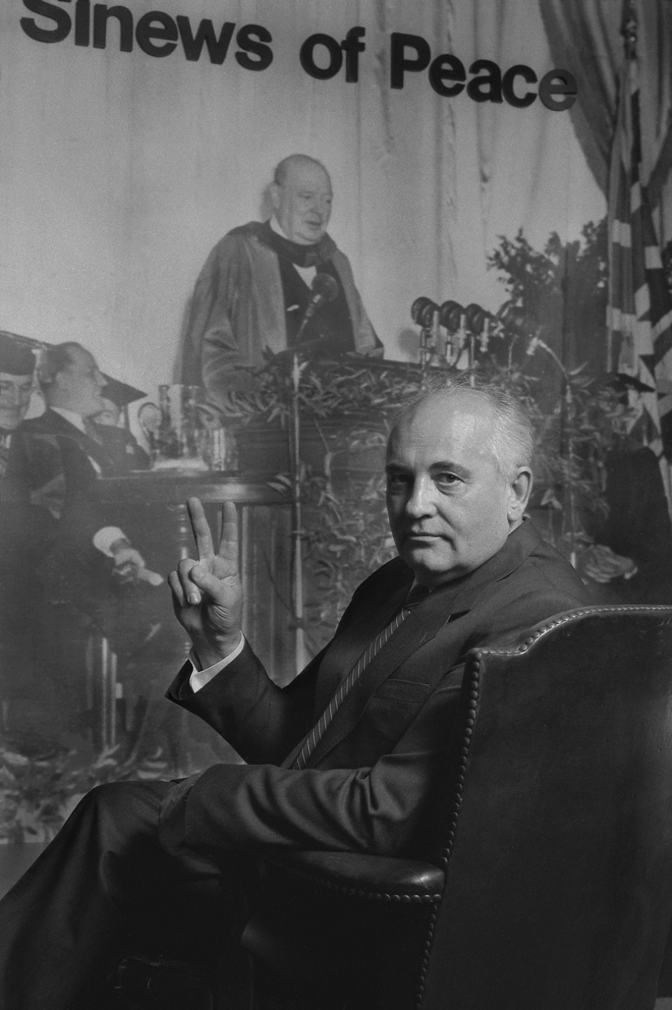 Mikhail Gorbachev with a poster of Winston Churchill delivering his famous Sinews of Peace speech where he makes the first mention of The Iron Curtain. Gorbachev is embodying Churchill's famous "V for Victory" pose. © David Spielman