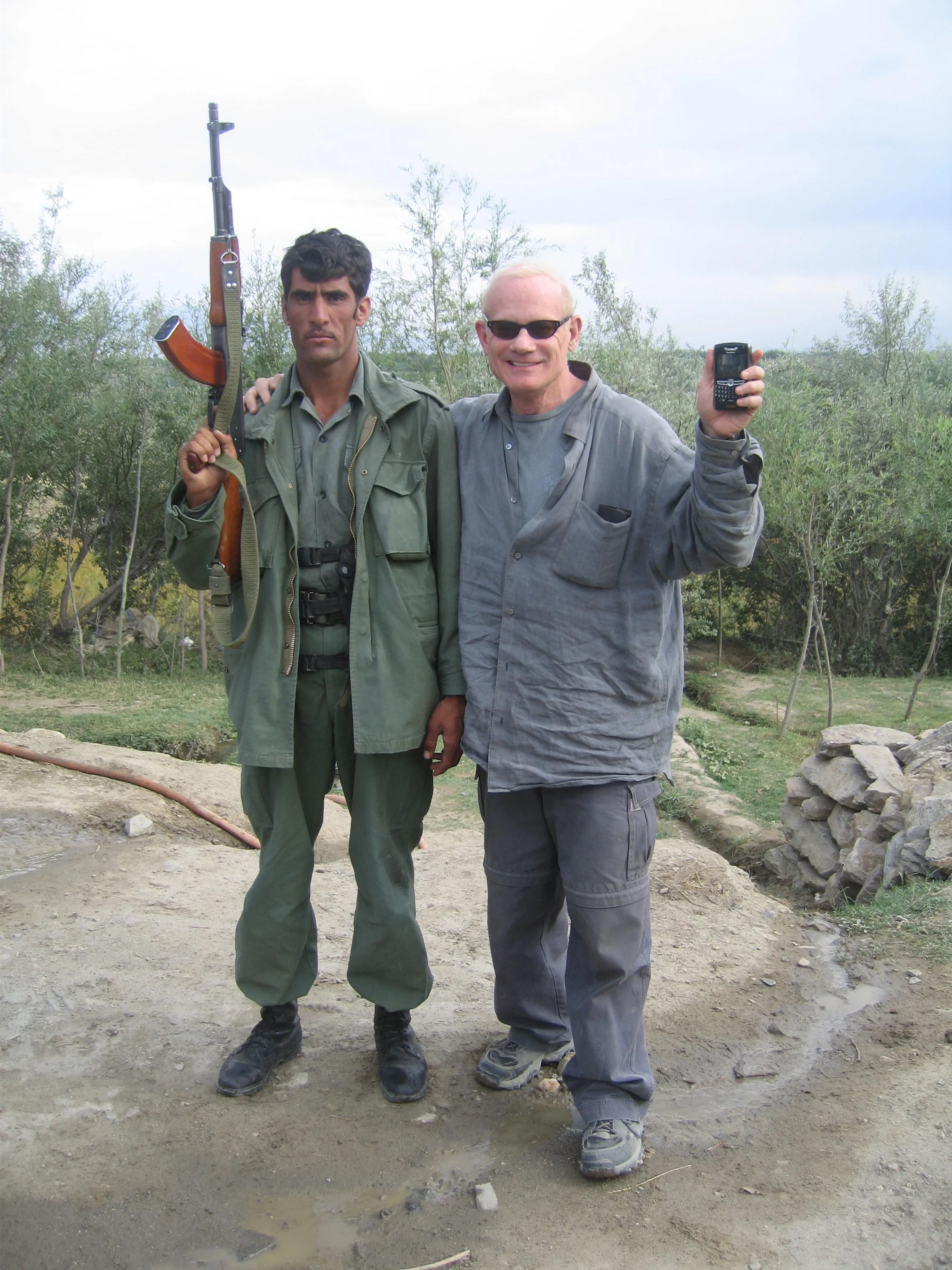 With an Afghani soldier on the left, showing
our preferred weapons.
