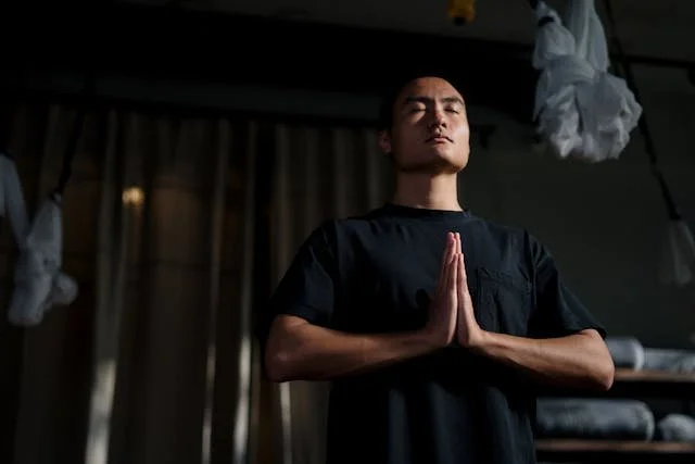An Asian male performing a yoga pose and breathing deeply representing trauma therapists who specialize in attachment styles in the Pasadena, Monrovia, Sierra Madre, and Los Angeles, California