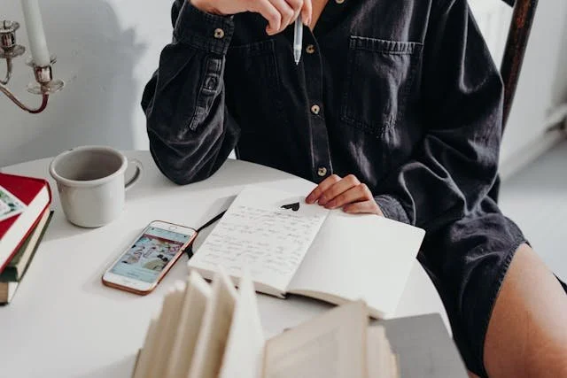 A person journaling and drinking coffee representing EMDR therapists who specialize in attachment styles in the Pasadena, Monrovia, Sierra Madre, and Los Angeles, California