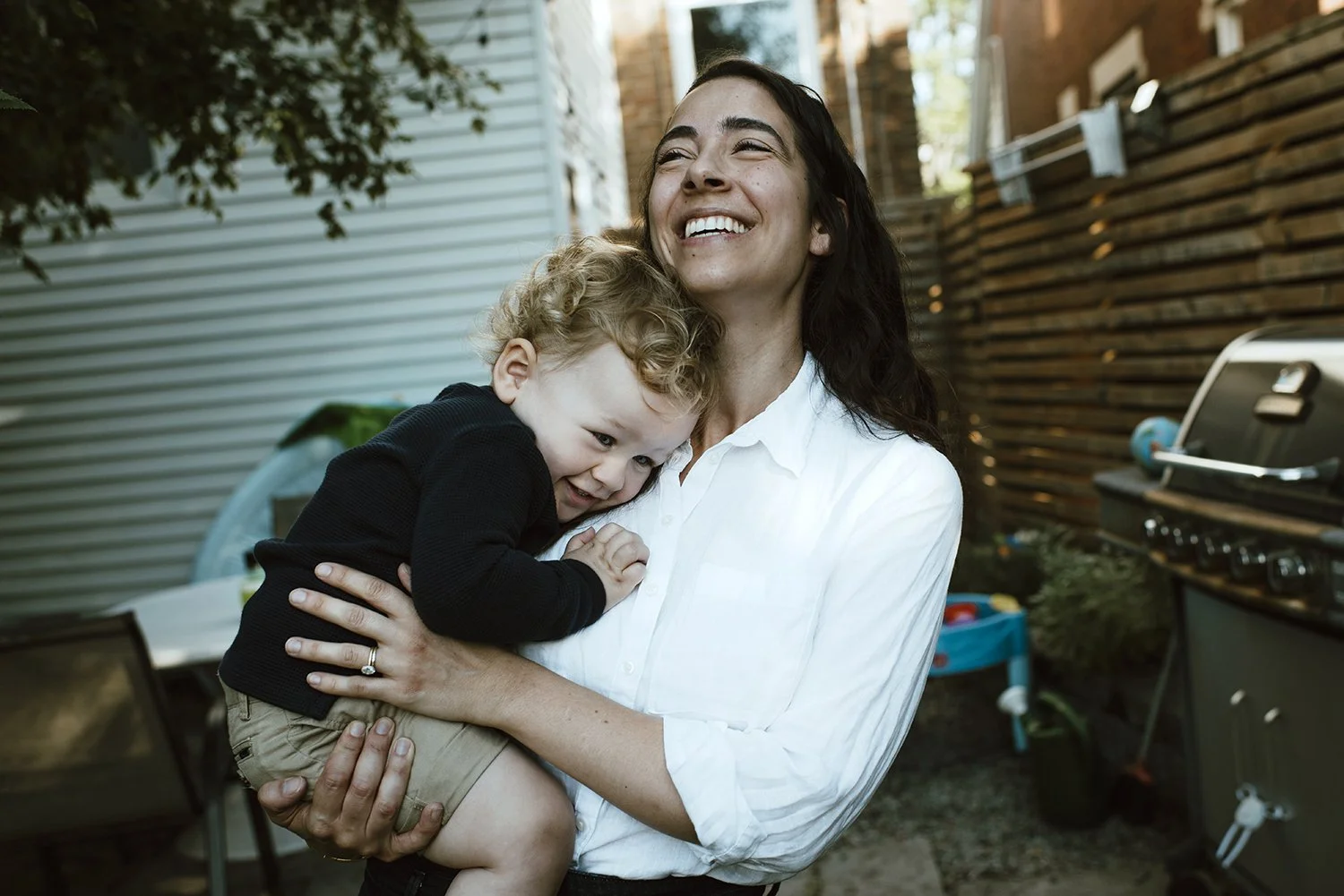 lifestyle photography of mom with son in backyard at home in toronto