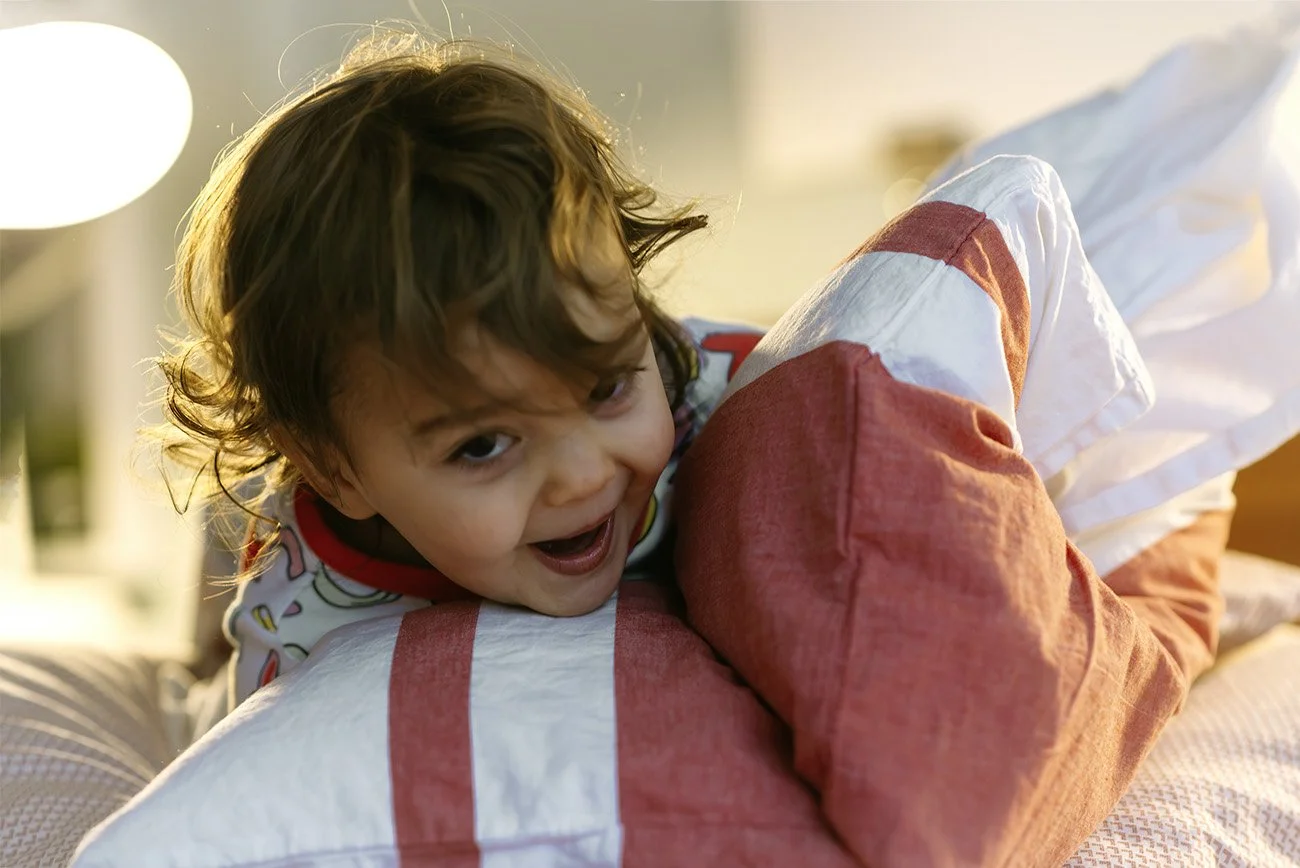 A toddler building a pillow fort at home in leslieville
