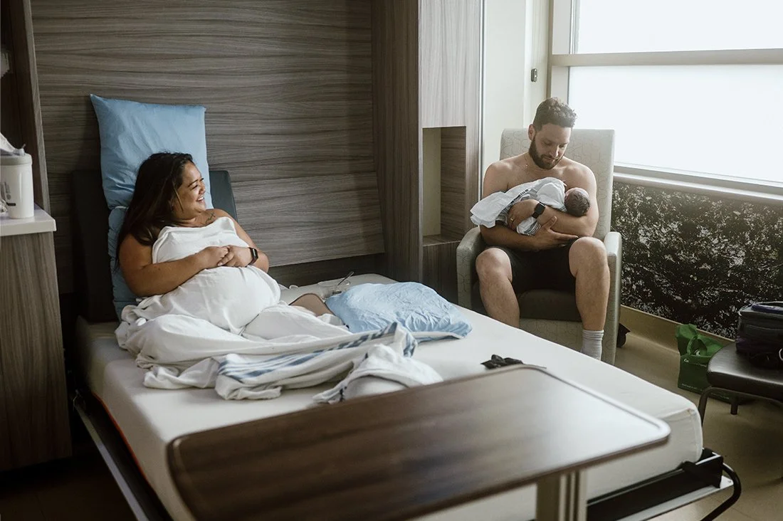 new parents with baby in hospital after birth photo