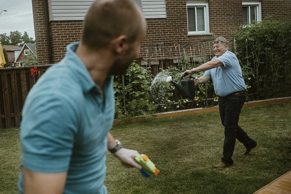 Grandparents with grown kids in backyard in toronto