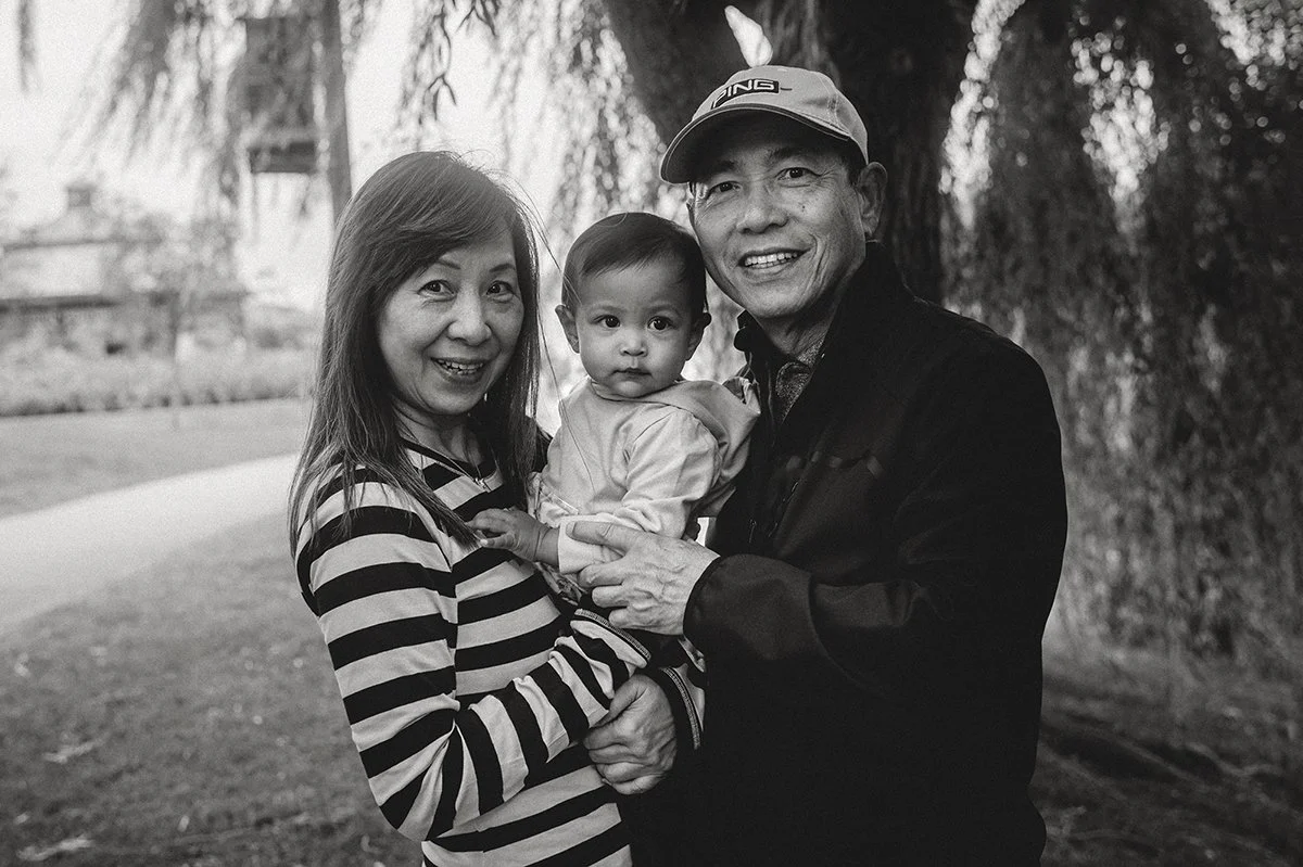 black and white film photo of grandma and grandpa with grandkid at a park in toronto
