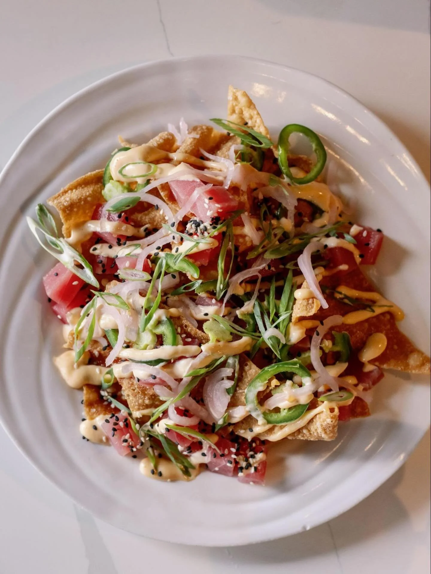 Nacho average tuna 🍣

Ahi Tuna Nachos | crispy wonton chips, pickled shallots, jalape&ntilde;os, avocado, sriracha aioli, scallions, sesame seeds