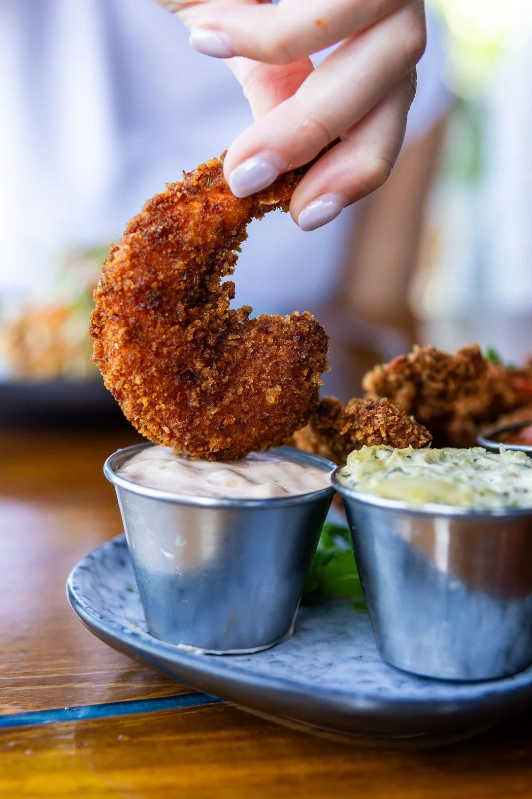 Made for dunking, built for sharing.

Our Fried Jumbo Shrimp comes crispy and golden with chili remoulade, artichoke tartar, and classic cocktail sauce.