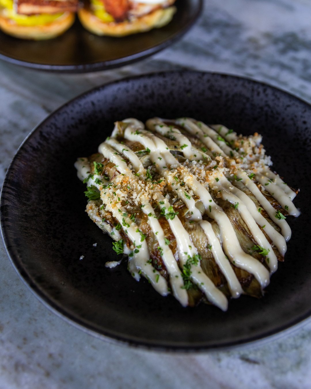 A little char, a little crunch, and plenty of flavor. 

Our grilled artichoke is finished with lemon, garlic aioli, and toasted chile breadcrumbs.