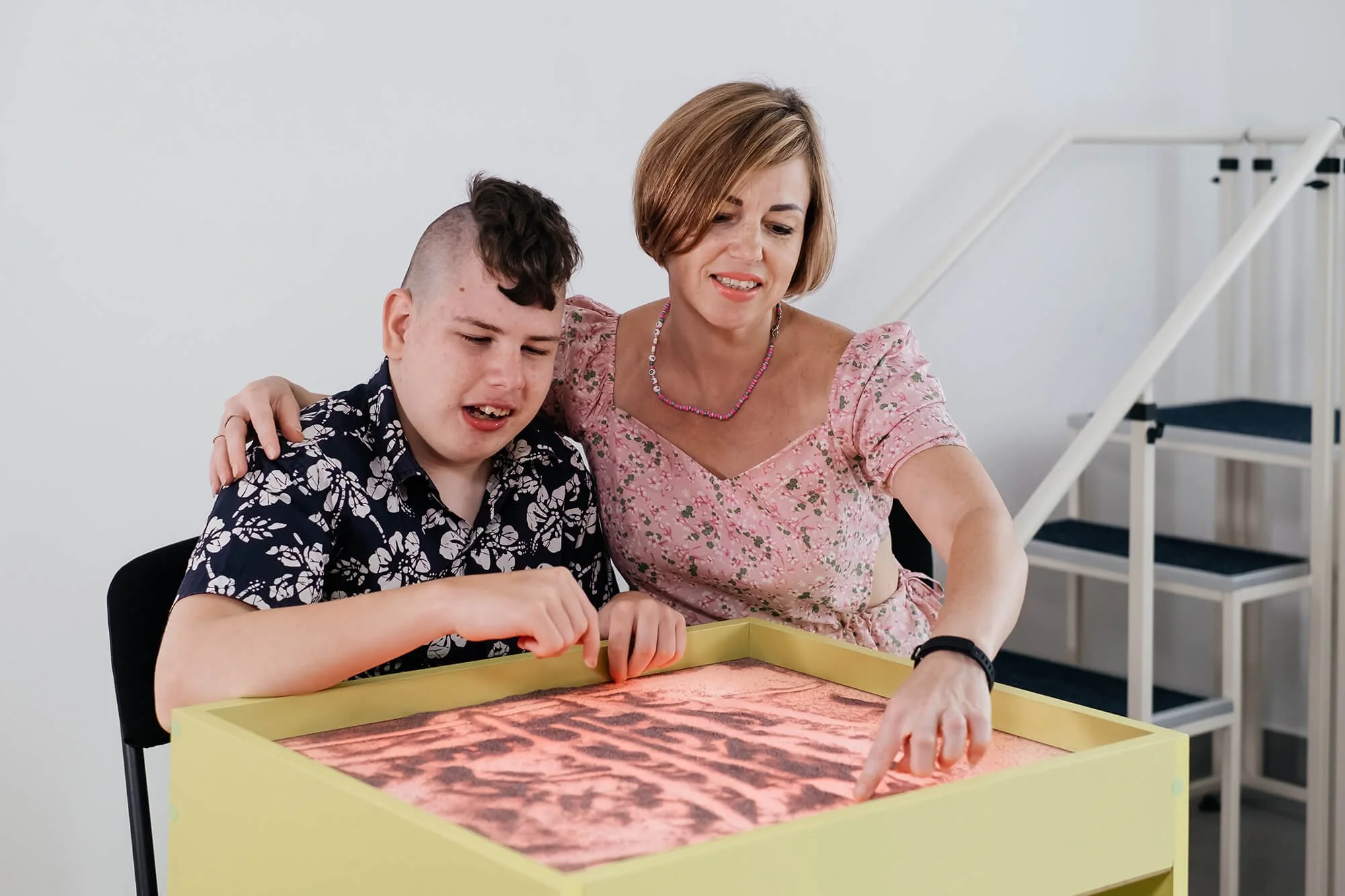 disabled-child-doing-sensory-activity-with-sand-rehabilitation.jpg
