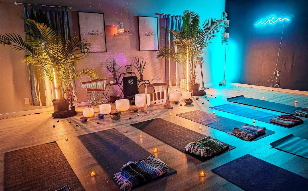 Frosted crystal singing bowls and wellness props arranged for a therapeutic sound bath and meditation session in a low-stimulation environment.