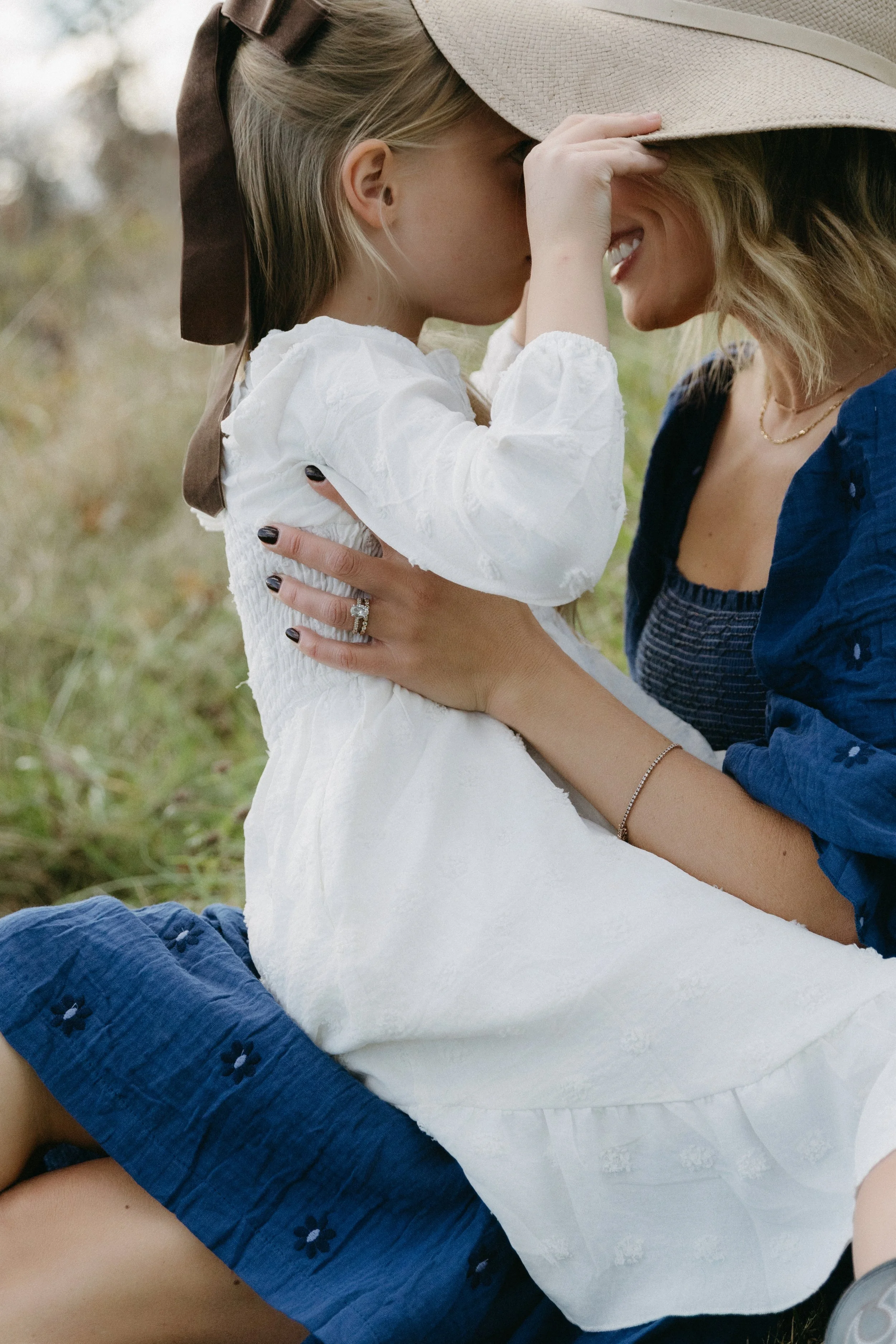 A portrait of a mother and daughter, sharing an intimate moment outdoor, photographed by Maison Mancel.