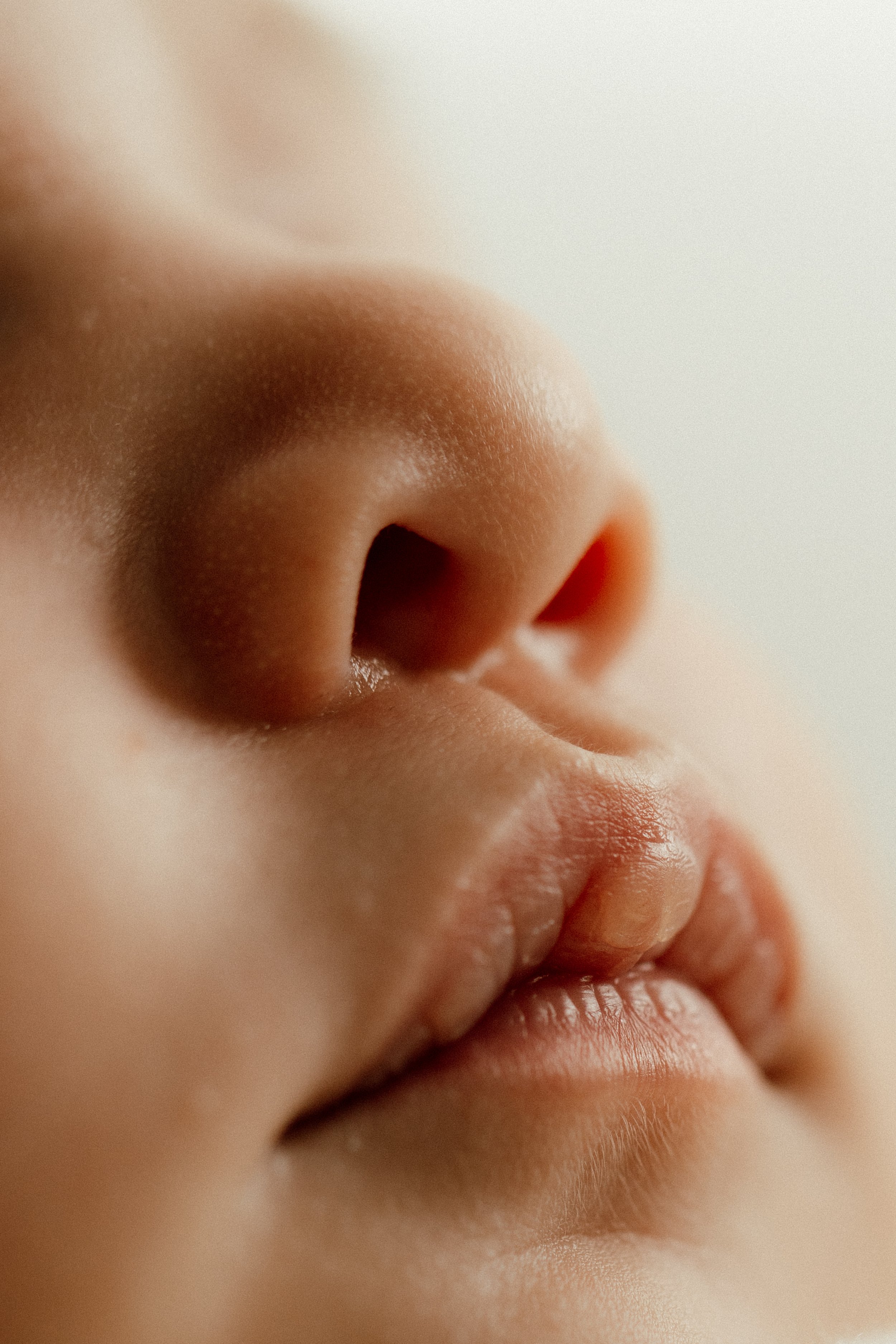 Newborn detail shot of a baby's nose, lips, and part of the cheek with soft skin and natural lighting taken in-studio in Brooklyn by Maison Mancel.