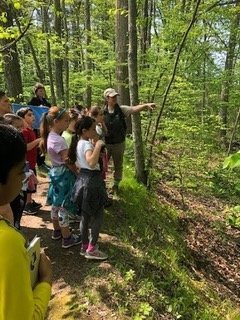   A Caratunk naturalist leads Ms. Hopkins’ third grade class on their trail hike through this Audubon Refuge.  
