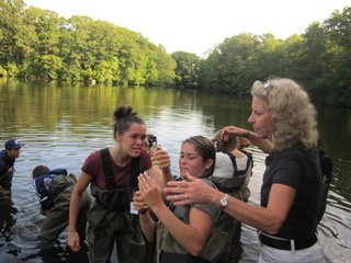   AP Biology teacher and science department chair, Ms. Angela Cunard, with former students Allison Houle and Emily DiBiase, take measurements during their study of water quality at Burr’s Pond.  