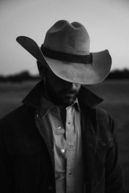 Cowboy wearing a Stetson hat at Stardust Ranch in Round Top, Texas, photographed as part of a western lifestyle brand activation and destination marketing campaign.