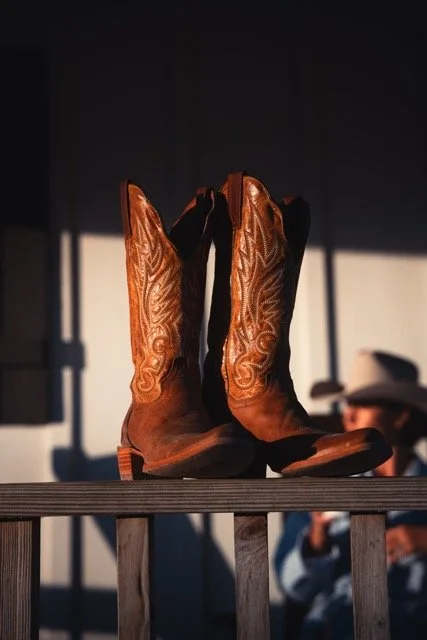 Luxury western lifestyle photography featuring Dan Post cowboy boots on the porch of Stardust Ranch in Round Top, Texas, captured as part of a brand activation and content marketing campaign.