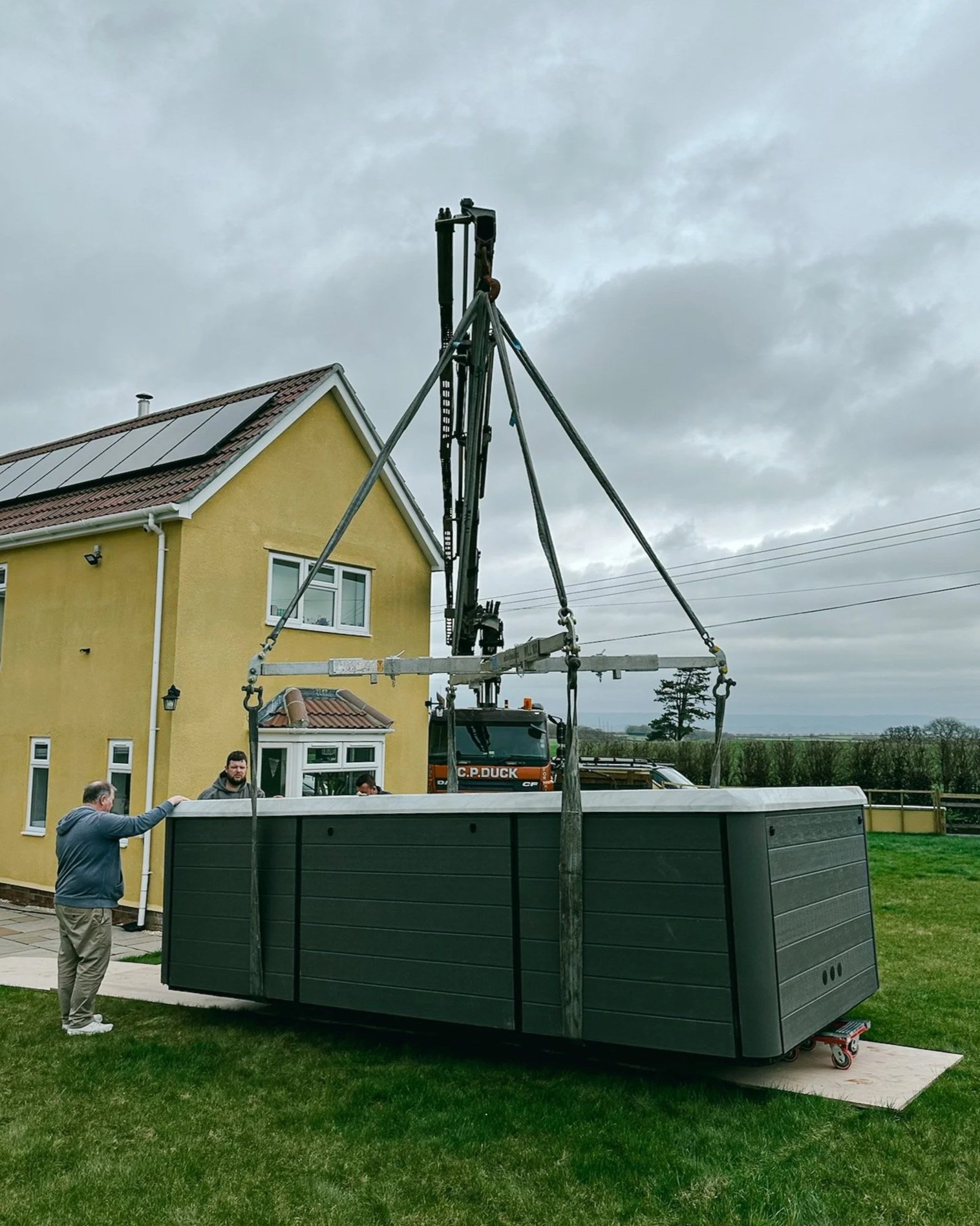 crane assisted hot tub delivery Somerset" or "HIAB lorry lifting hot tub Somerset garden