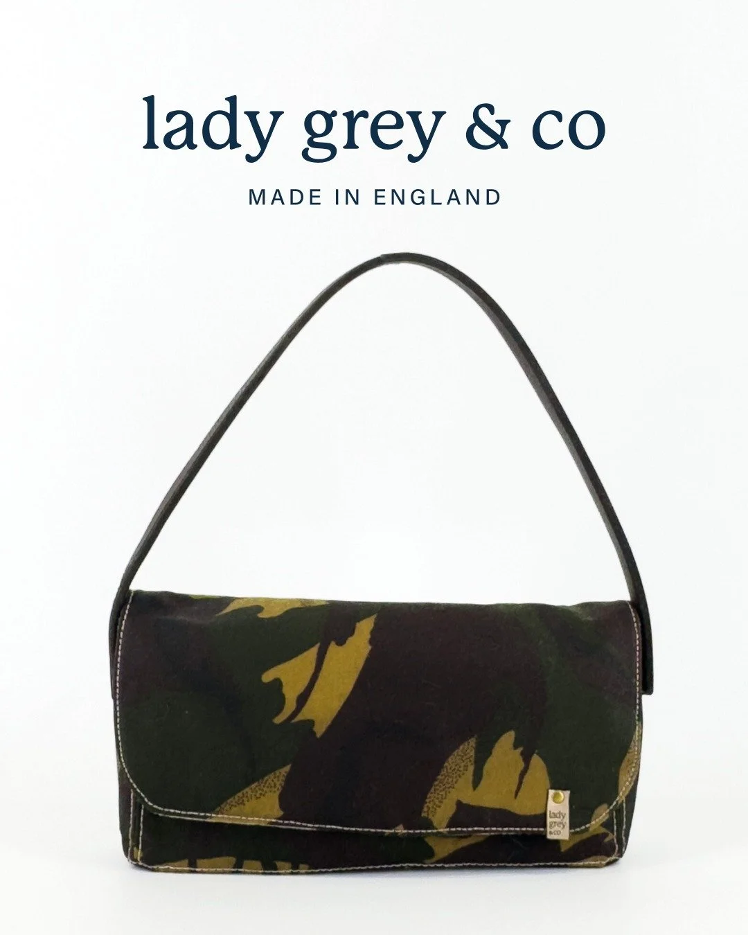 Meet the Bettiana &ndash; Camo,  a beautifully balanced shoulder bag crafted for everyday elegance.

Handmade in England using durable waxed camo cotton, premium upholstery fabric, and finished with a strap made from the noseband of a retired polo po