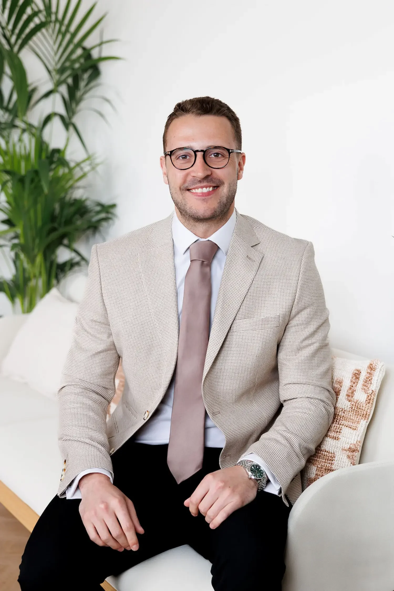 Sampson Fielding Managing Partner Elliot Fielding ACA sitting on a sofa at their chartered accountancy firm in Central London