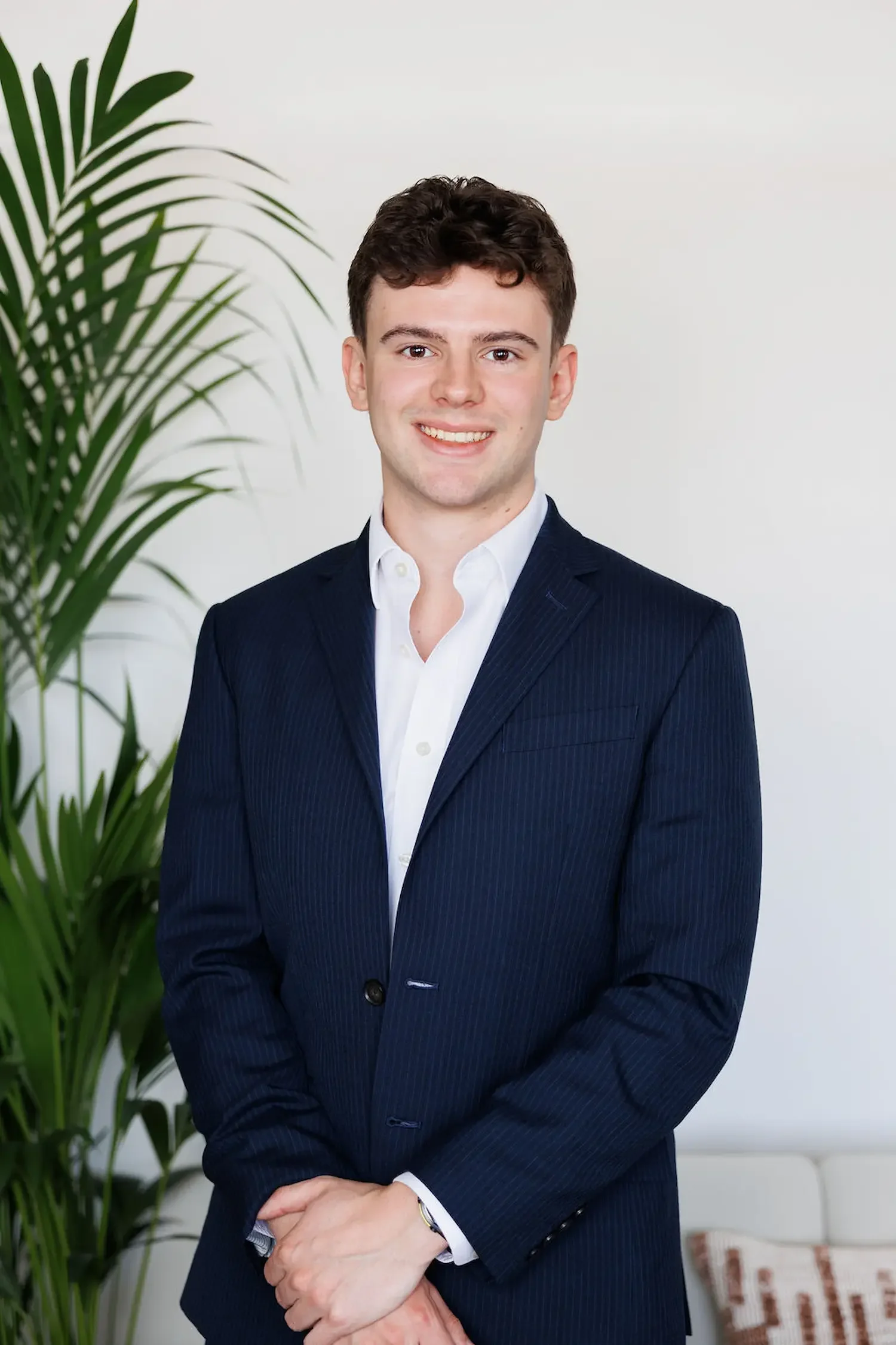 Sampson Fielding Assistant Manager Xander Dyer ACA CTA smiling and standing at their Central London business advisory firm