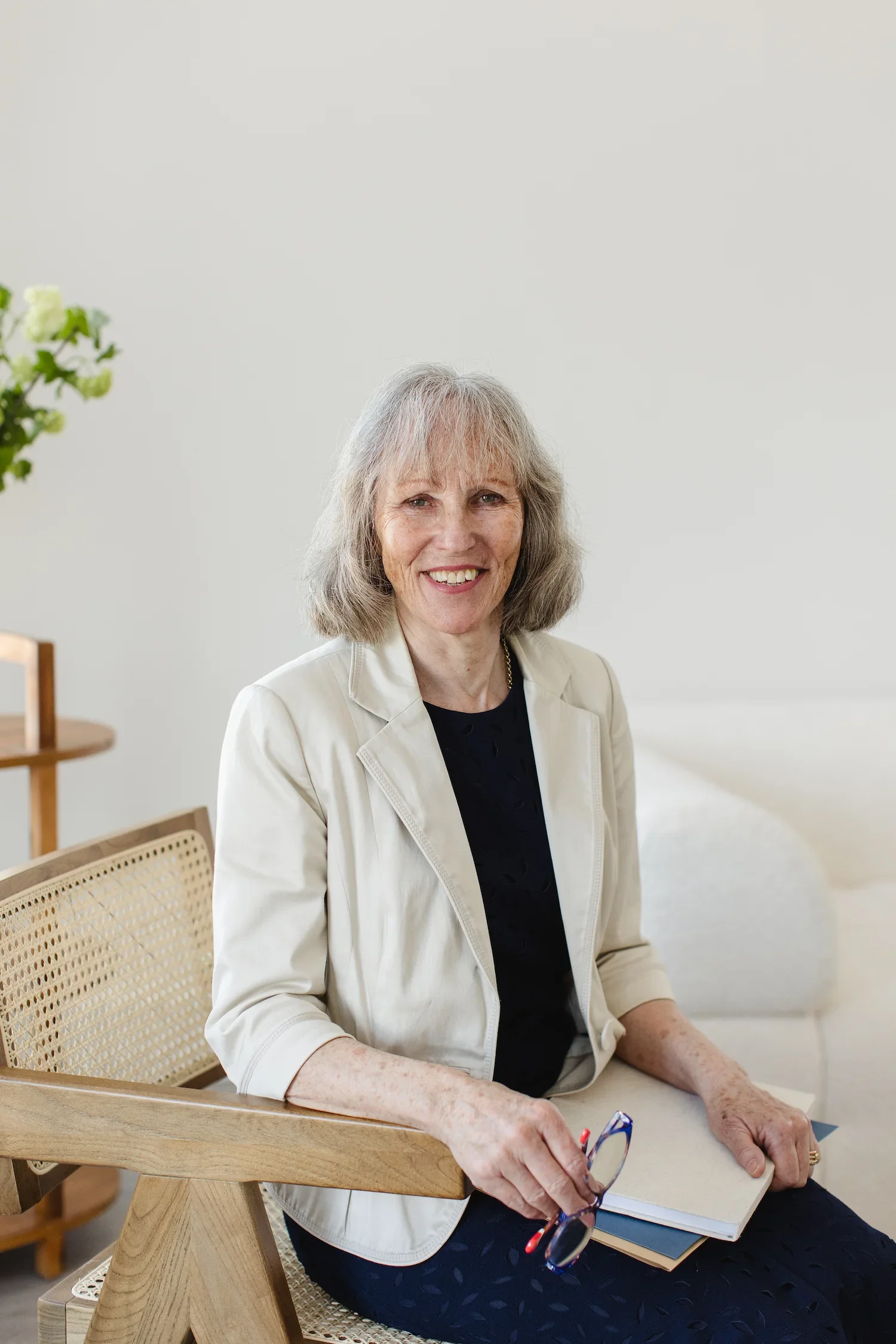 Sampson Fielding Manager Liz Blythe smiling and sitting on a chair at their Central London chartered accountancy practice