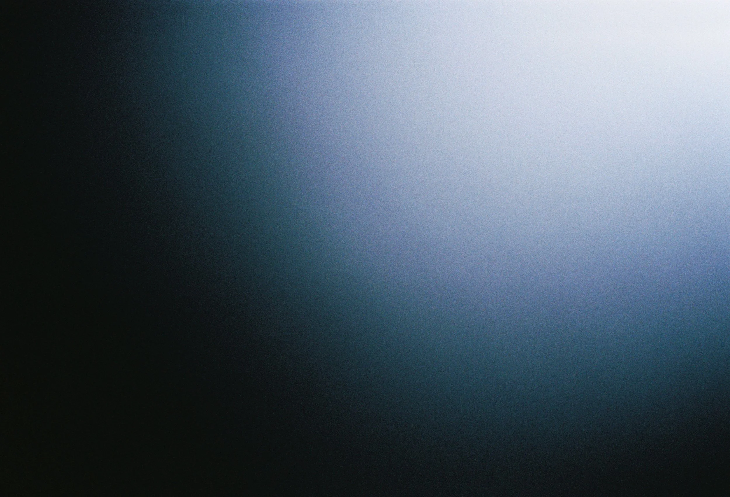 Blurred abstract background with a gradient from dark to light blue.