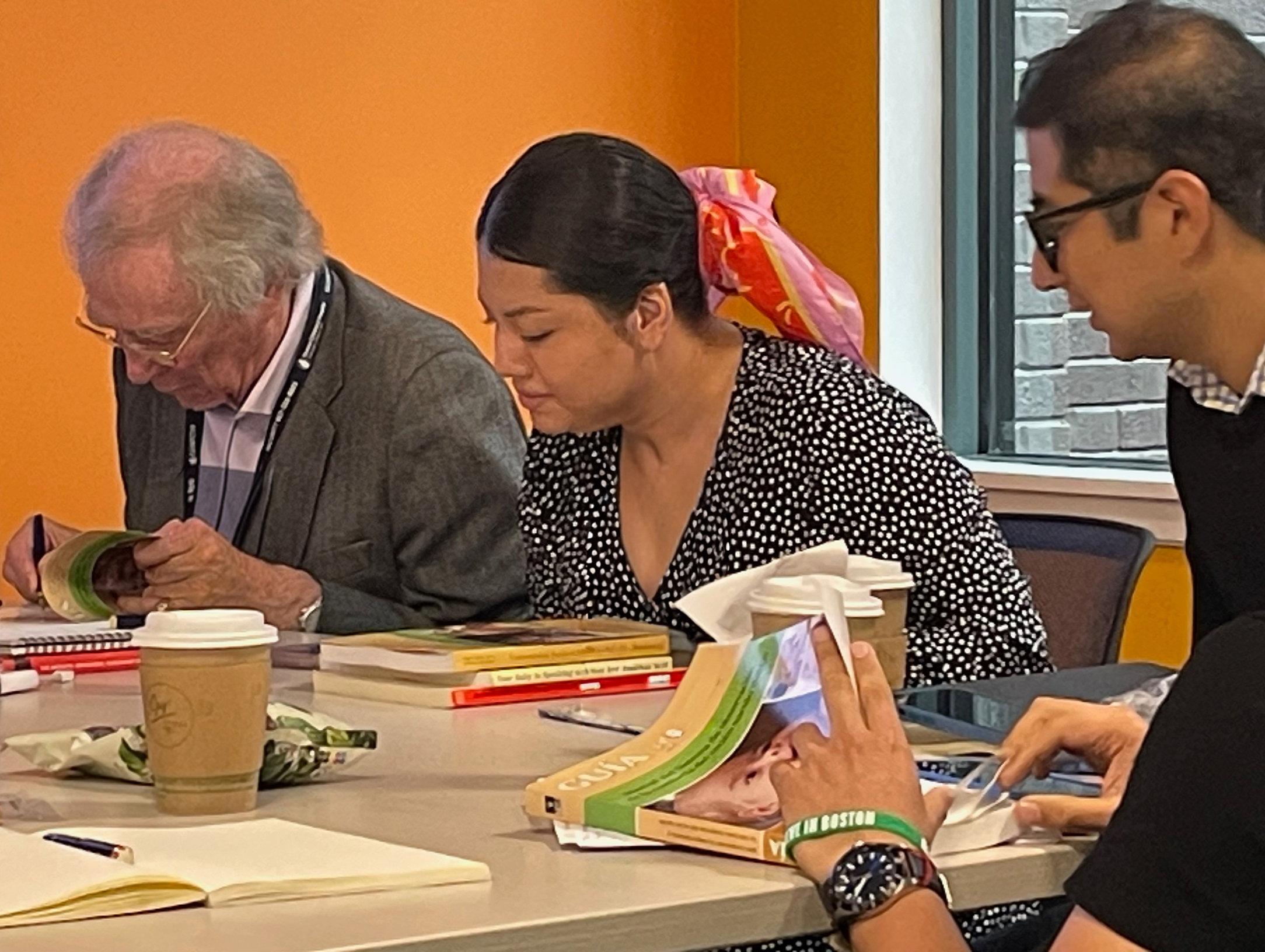 Participants taking notes during NBO training - learning evidence-based strategies for newborn assessment and family support. evidence-based newborn care, family support strategies, professional development.