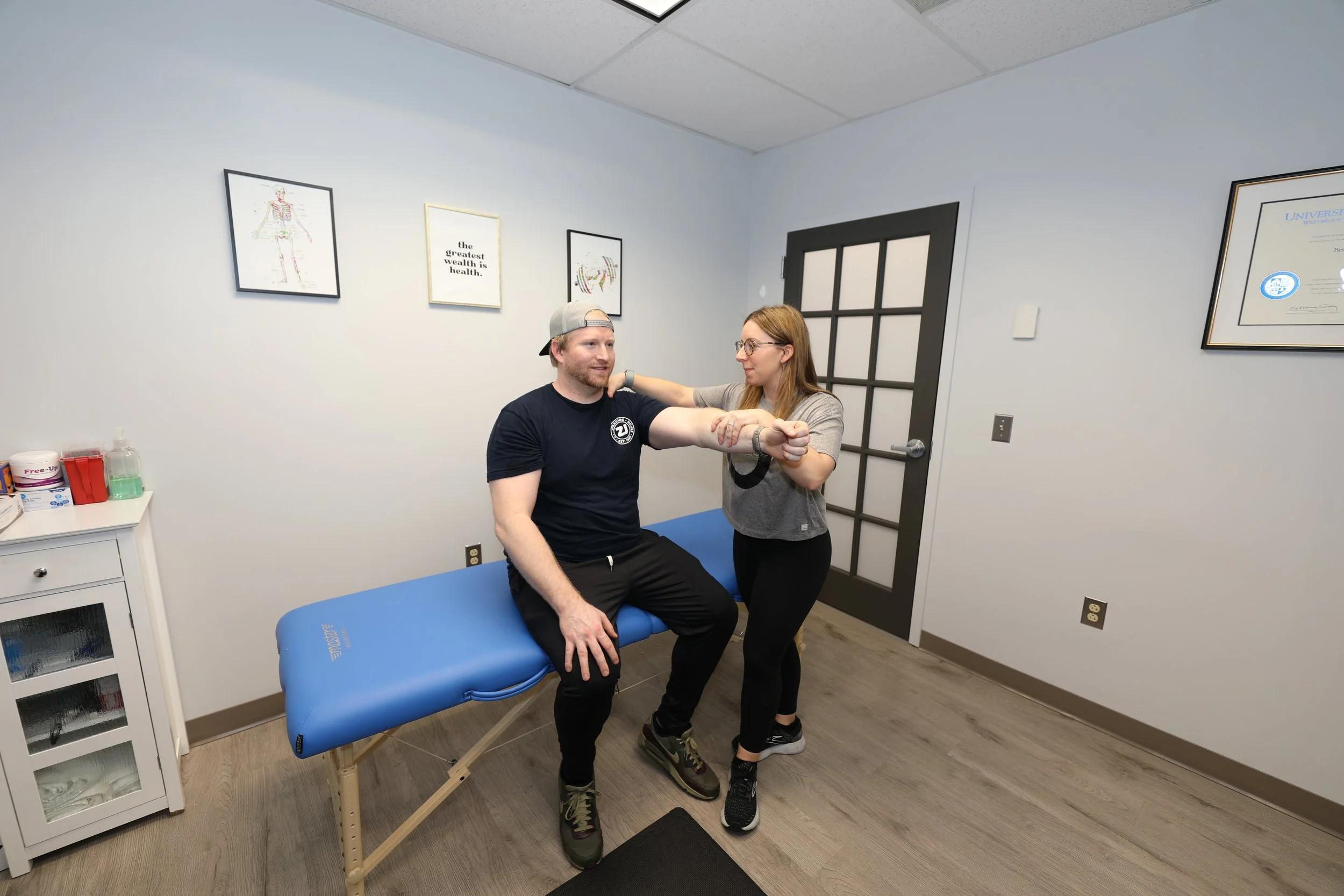 Physical therapist Dr. Bettie Bruce working one-on-one with patient during movement assessment at CoreMovement Physical Therapy clinic in Bryn Mawr PA