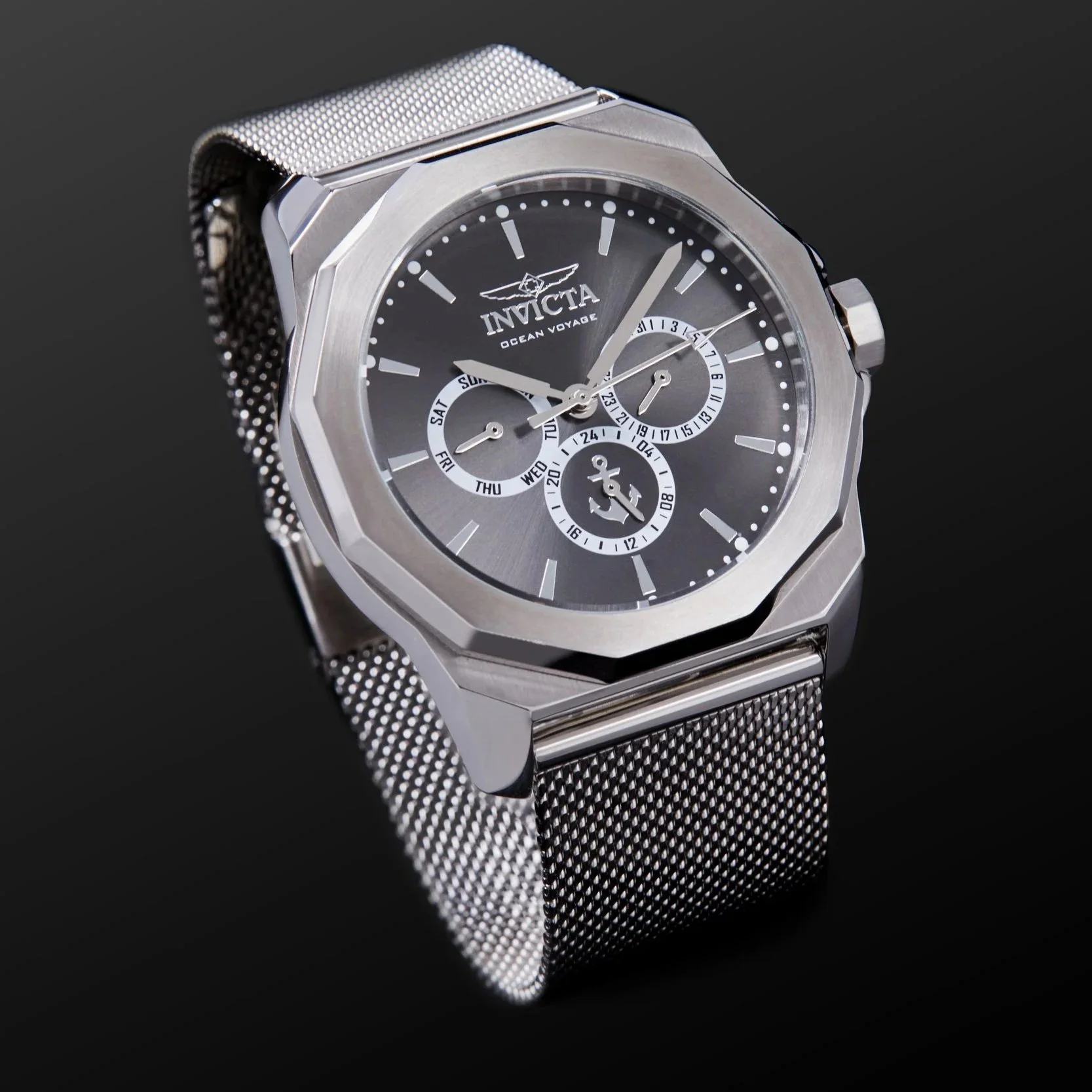 Silver wristwatch with black dial, multiple sub-dials, and mesh strap, branded 'Invicta Ocean Voyage'.