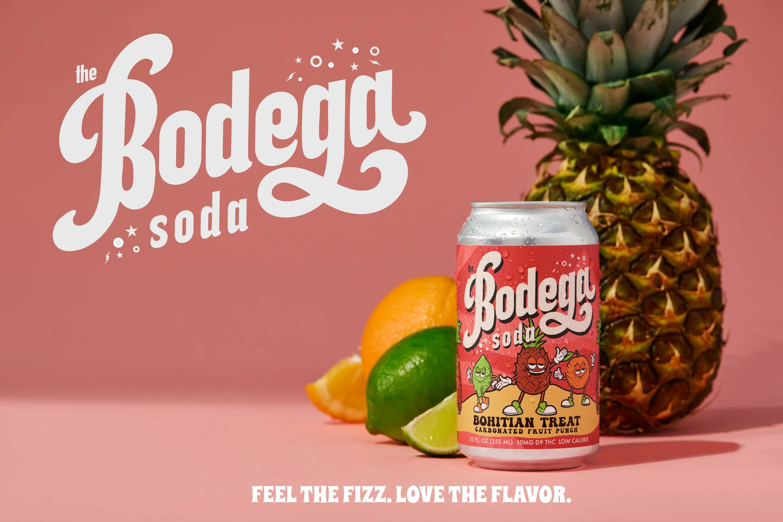 A can of Bodega soda with a tropical fruit theme, featuring a pineapple, oranges, and limes, against a pink background. The can has colorful cartoon characters and the flavor is Bohemian Treat carbonated fruit punch. The text on the background reads 