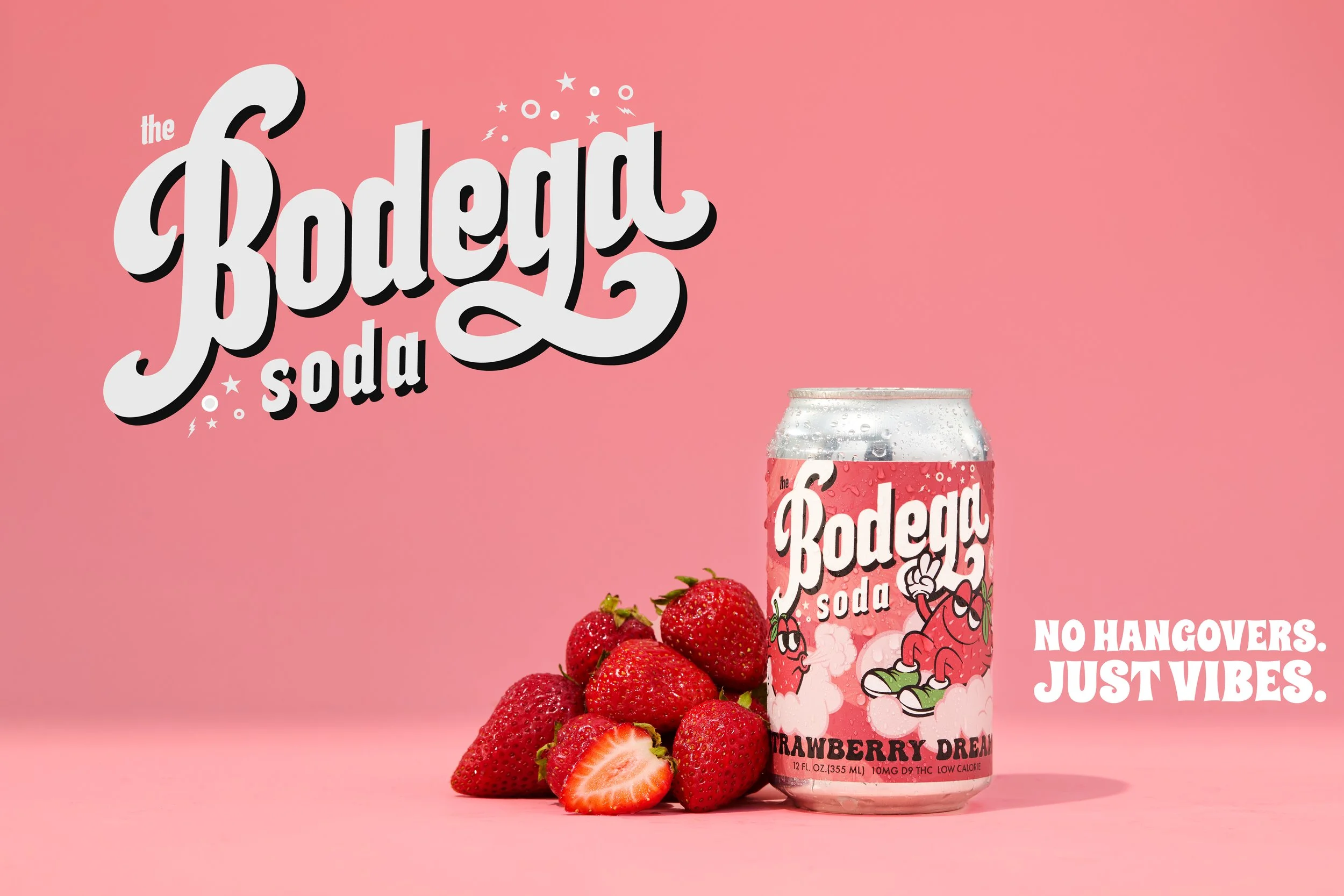 A pink can of the beverage 'Bodega Soda Strawberry Dream' with a cartoon strawberry character, surrounded by fresh strawberries and a pink background. The slogan 'No hangovers. Just vibes.' appears on the right side.