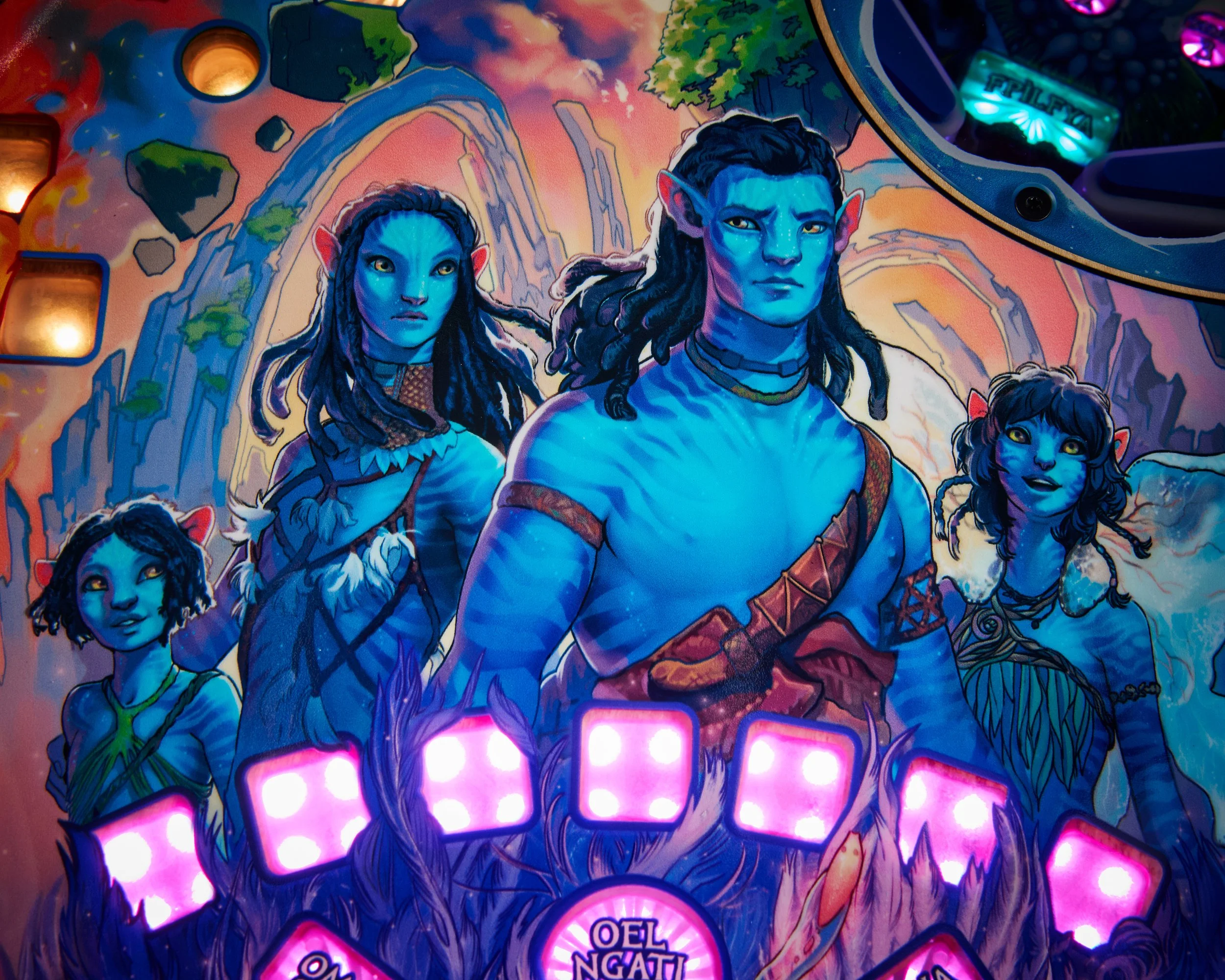A fantasy-themed pinball machine featuring blue-skinned humanoid characters with pointed ears, dressed in tribal attire, set against a colorful landscape with mountains and a sunset sky.