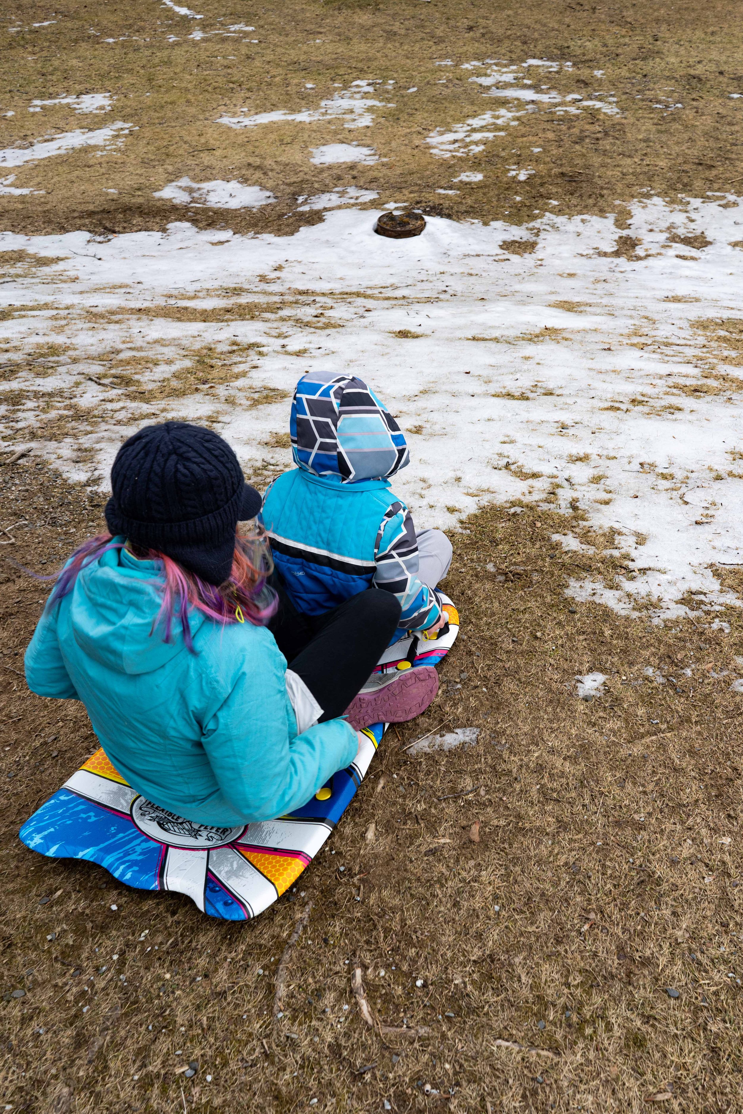 On February 20th, children sled down a grassy hill in Rockport with patches of snow