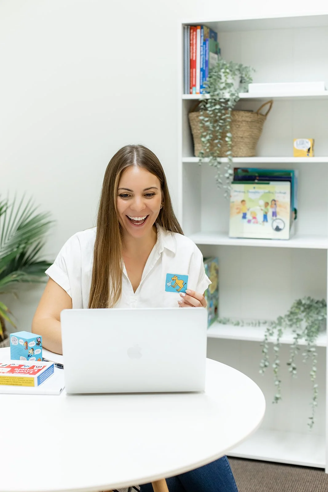 Speech therapist Gabby Pyzza holding an articulation flashcard during a virtual R sound speech therapy session
