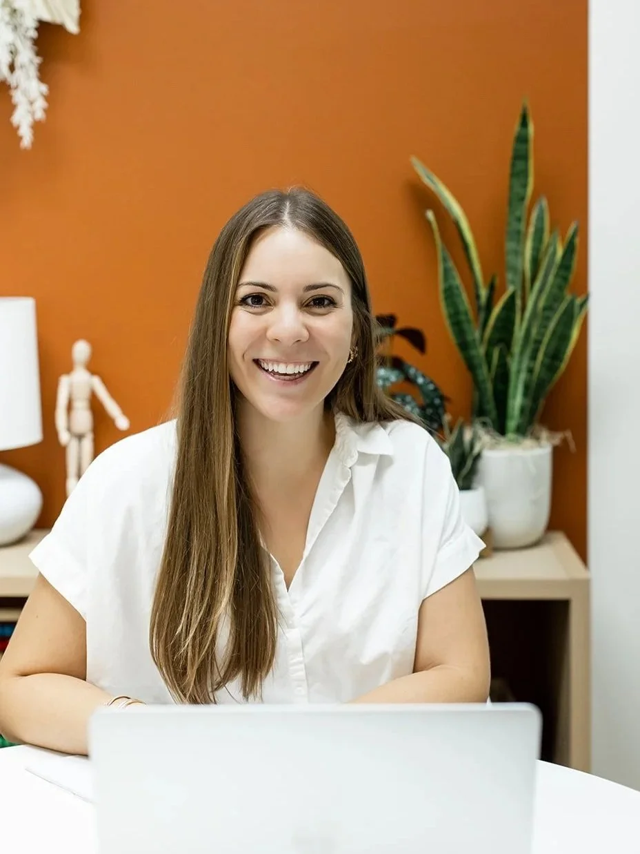 Gabby Pyzza, speech-language pathologist and CONNECT program leader, smiling at her laptop