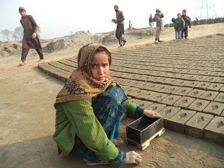 Girl making bricks.jpeg