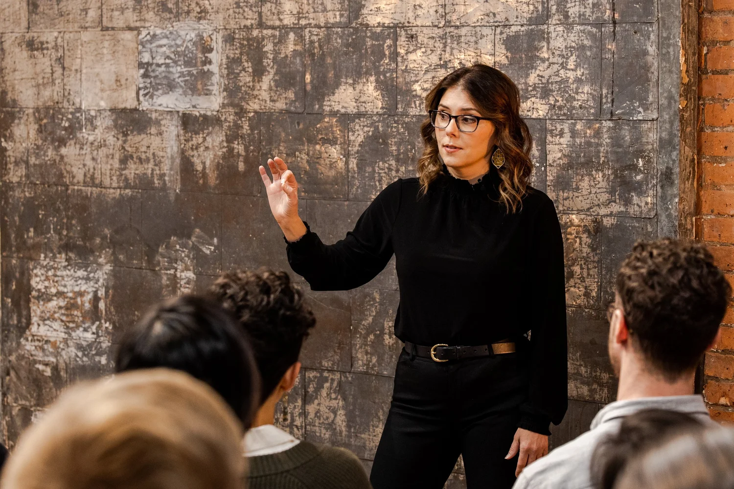 Jen Waldman speaking to a group at the studio