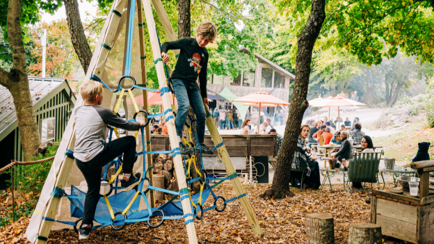 Children outside playing on a play ground smiling