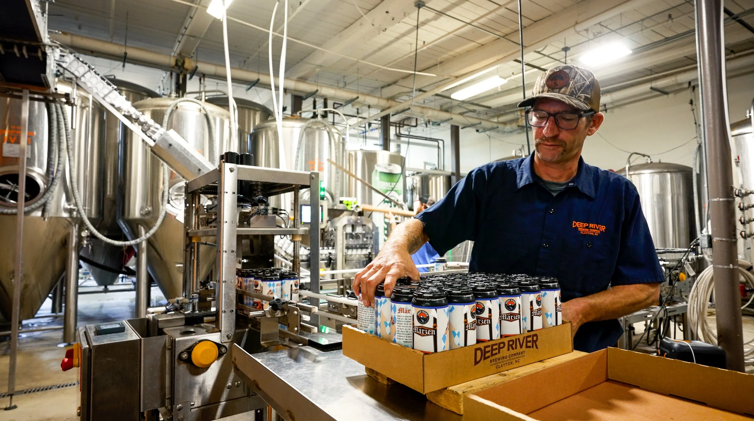 person canning in a production facility