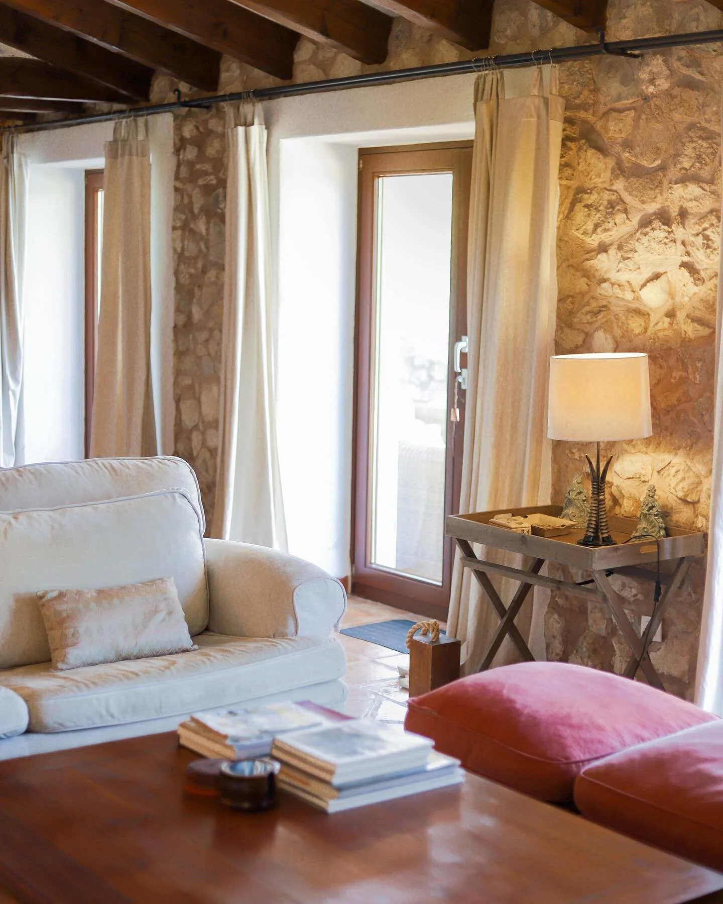 Cozy evenings by the fireplace are even better in our Finca Can Guillo living room, with direct access to the terrace and stunning views of the Puig de Maria mountain. Perfect for unwinding after a day exploring the nearby Pollensa town or the gorgeo
