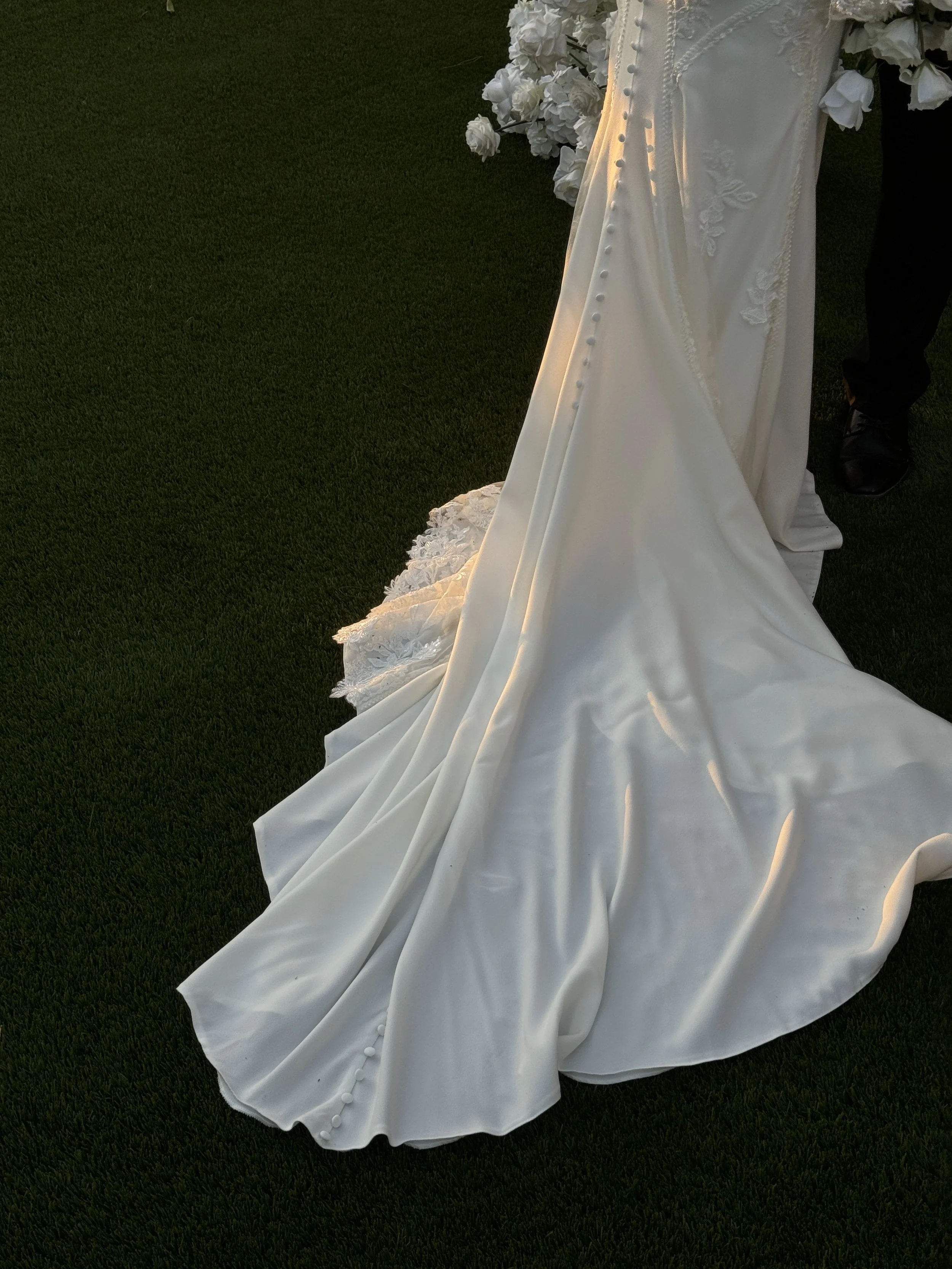 wedding dress train with floral embroidery on grass
