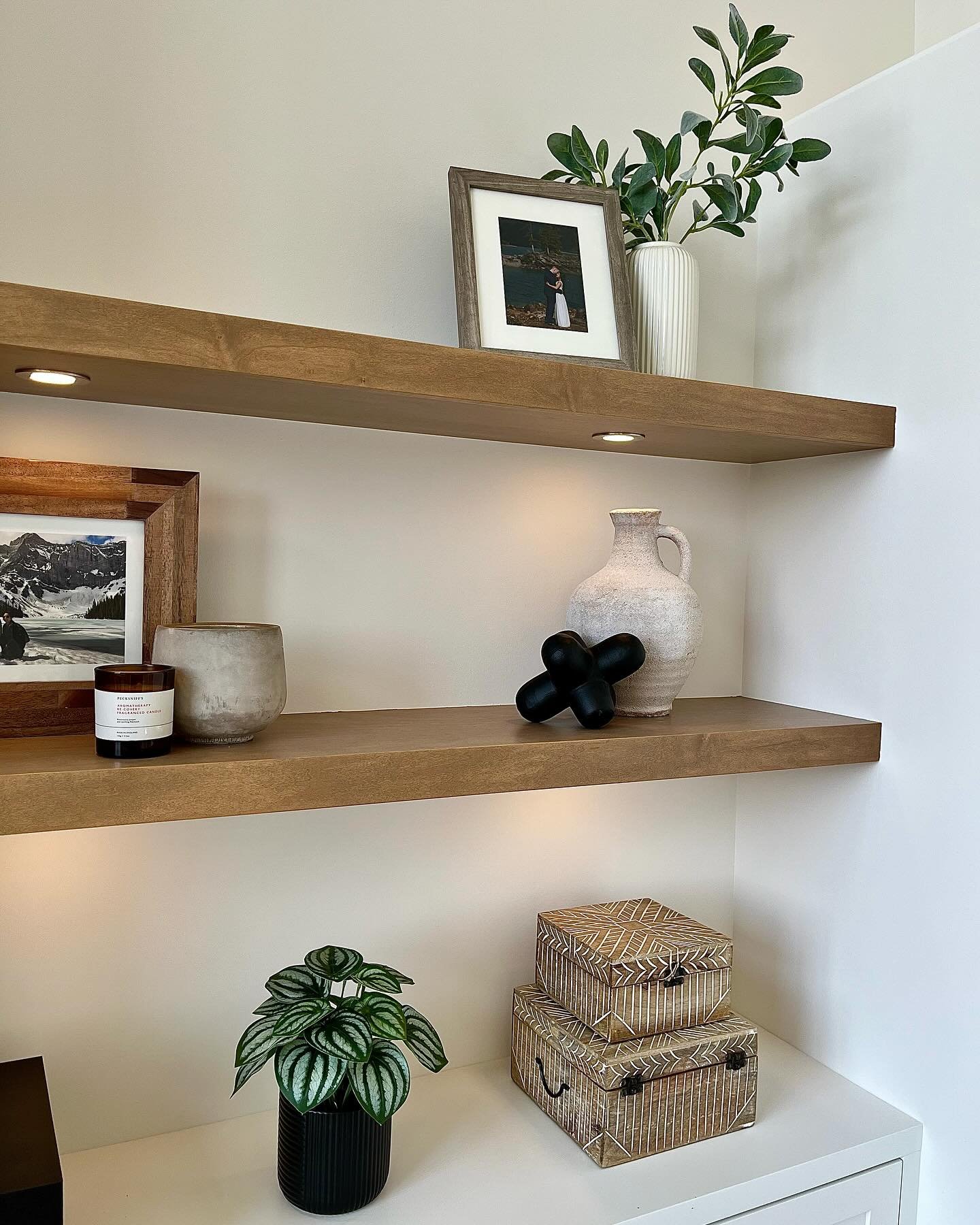 Maple floating shelves add the perfect amount of organic warmth to this great room and the floor to vaulted ceiling fireplace. 

My preference is always puck lights rather than LED strips in this installation. 
.
.
.
.
.
.
.
#floatingshelves #yycreno