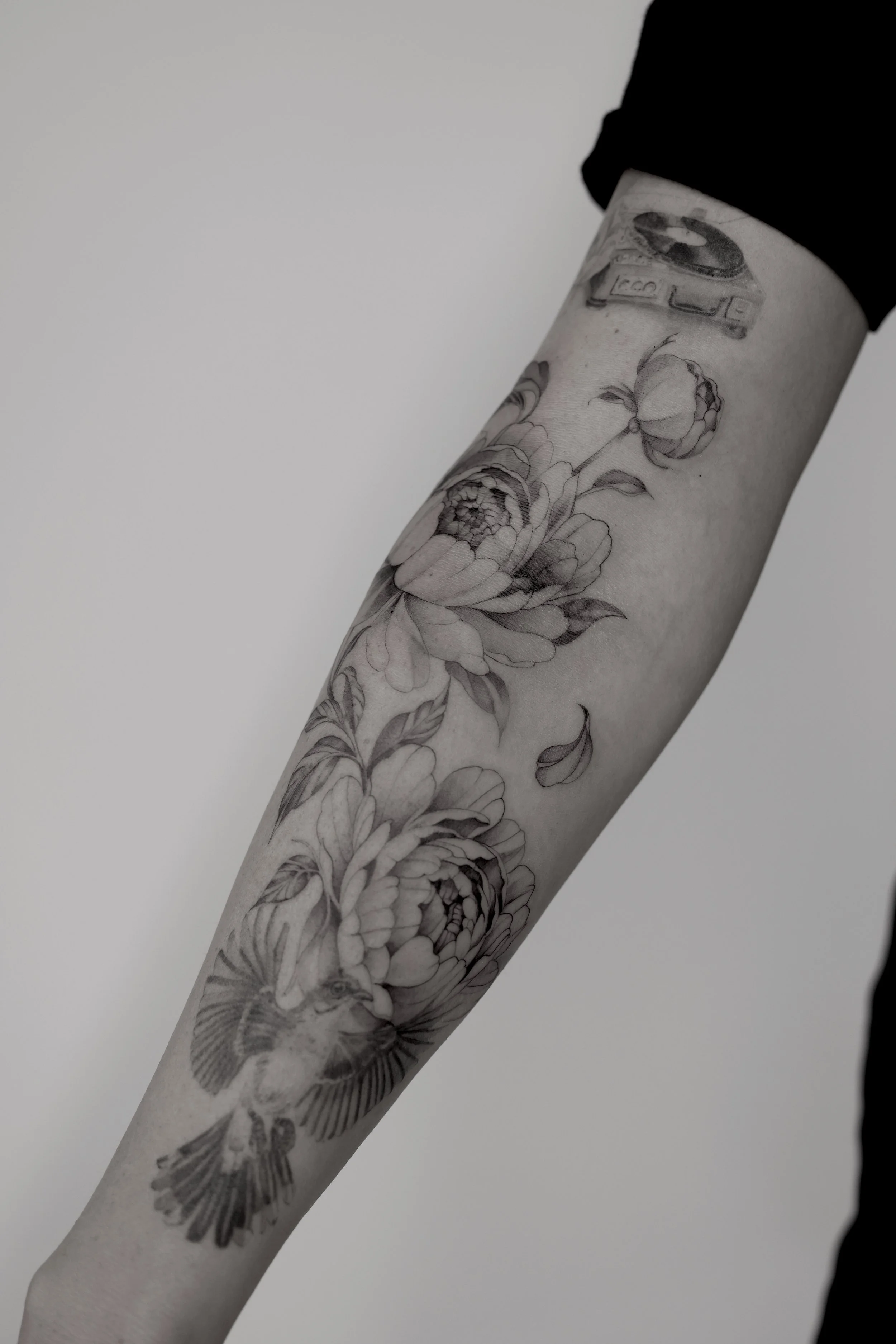 Peony tattoos from Ryane Rose that are fine line with soft shading 