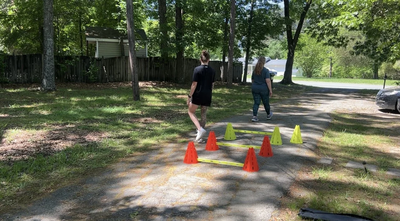 Silhouette of a person meditating outdoors at sunrise with palm trees in the background.
