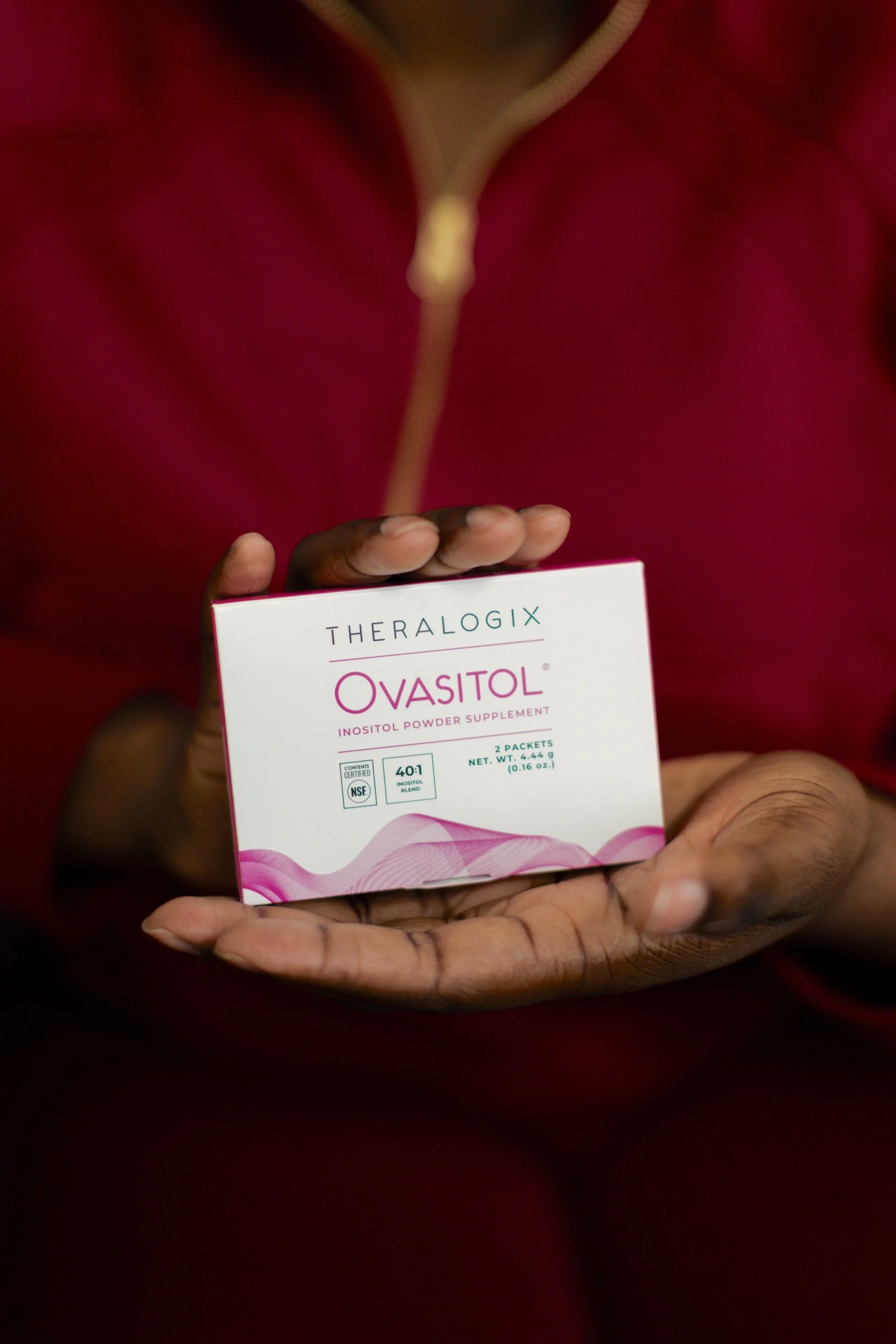 woman holding a box of vitamins in her hands